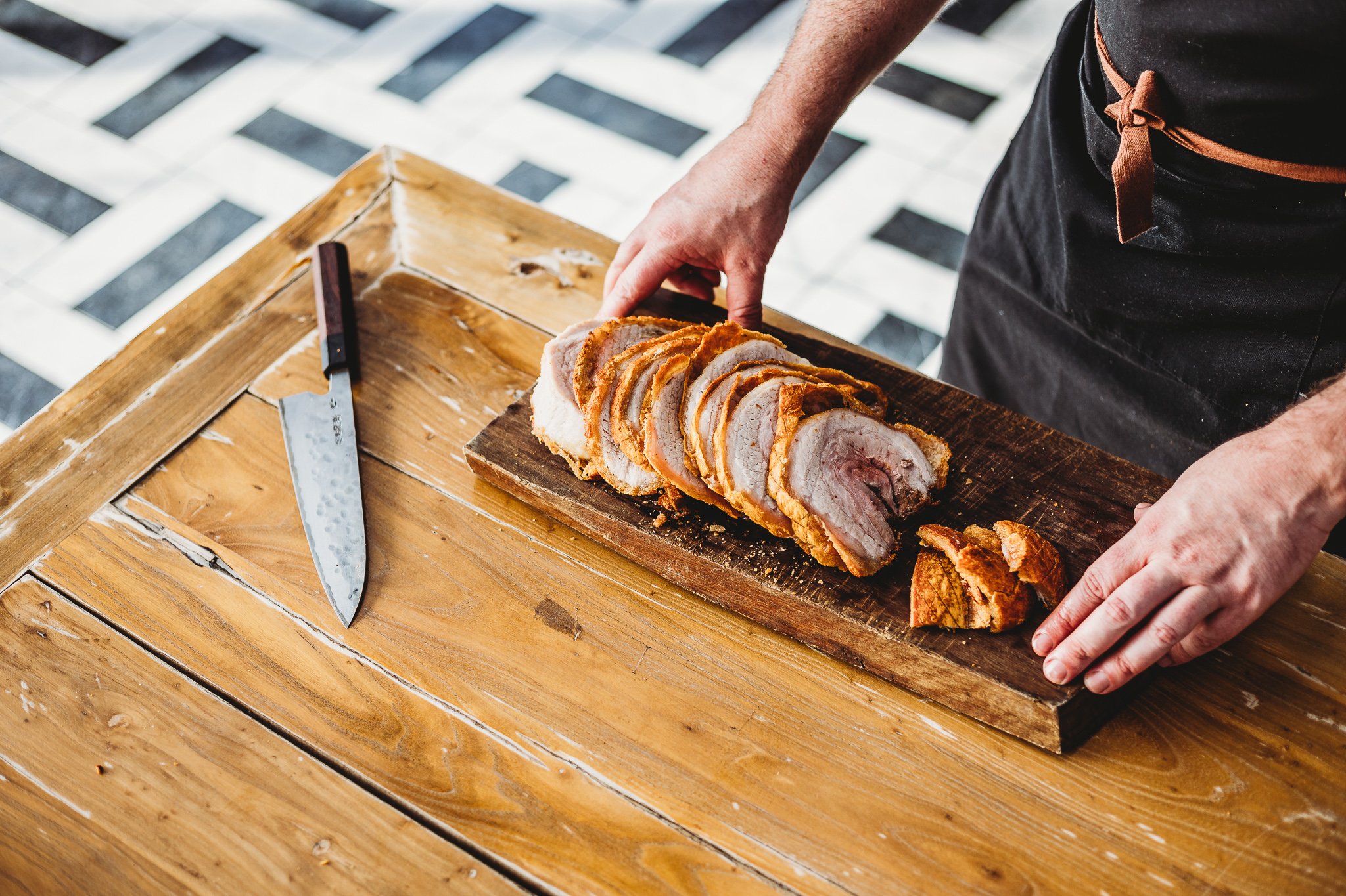 Canberra food photography - chef cuts roast pork (Copy)
