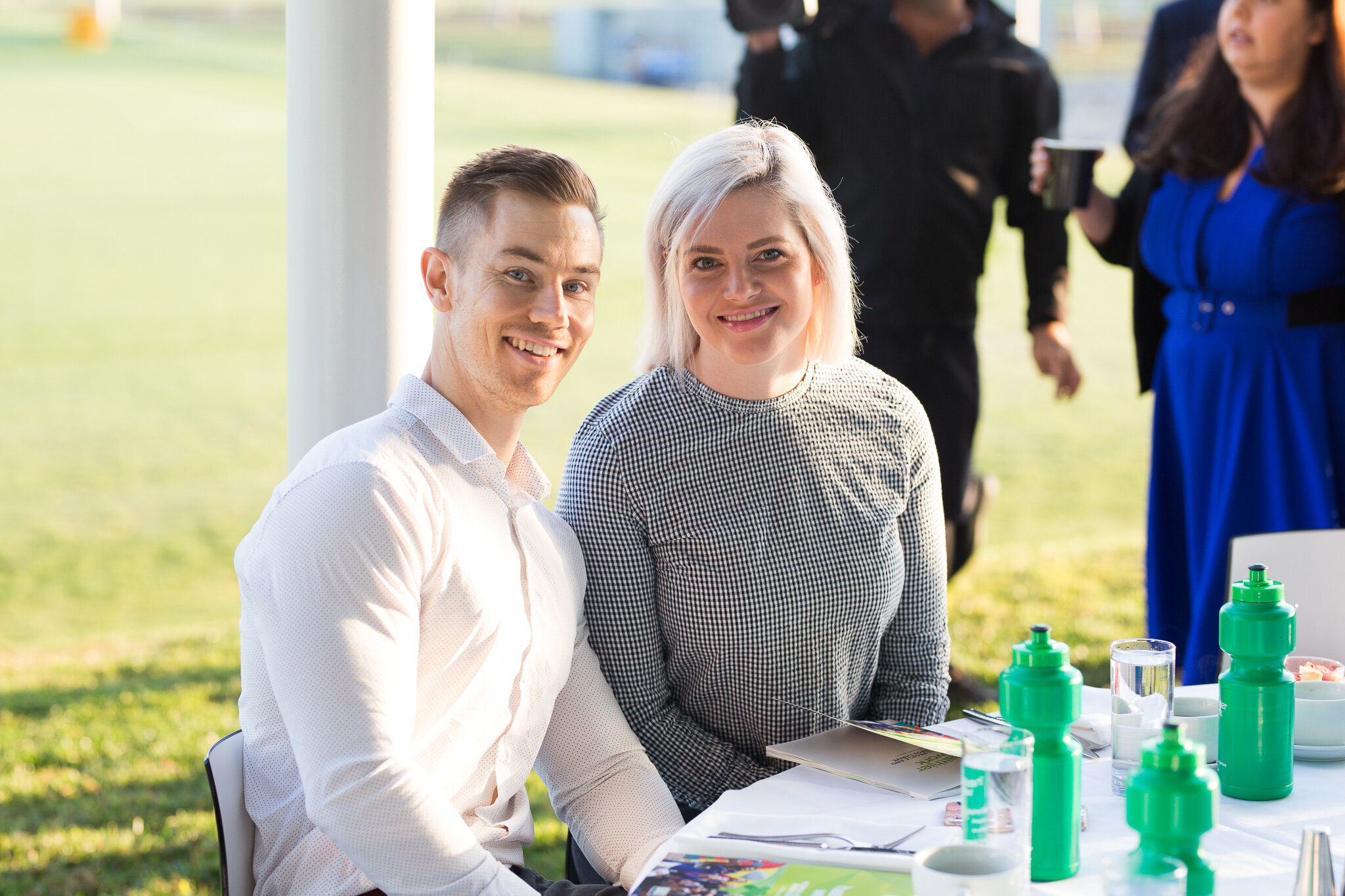 Canberra Event Photographer - Man and woman smile at camera in bright sunlight