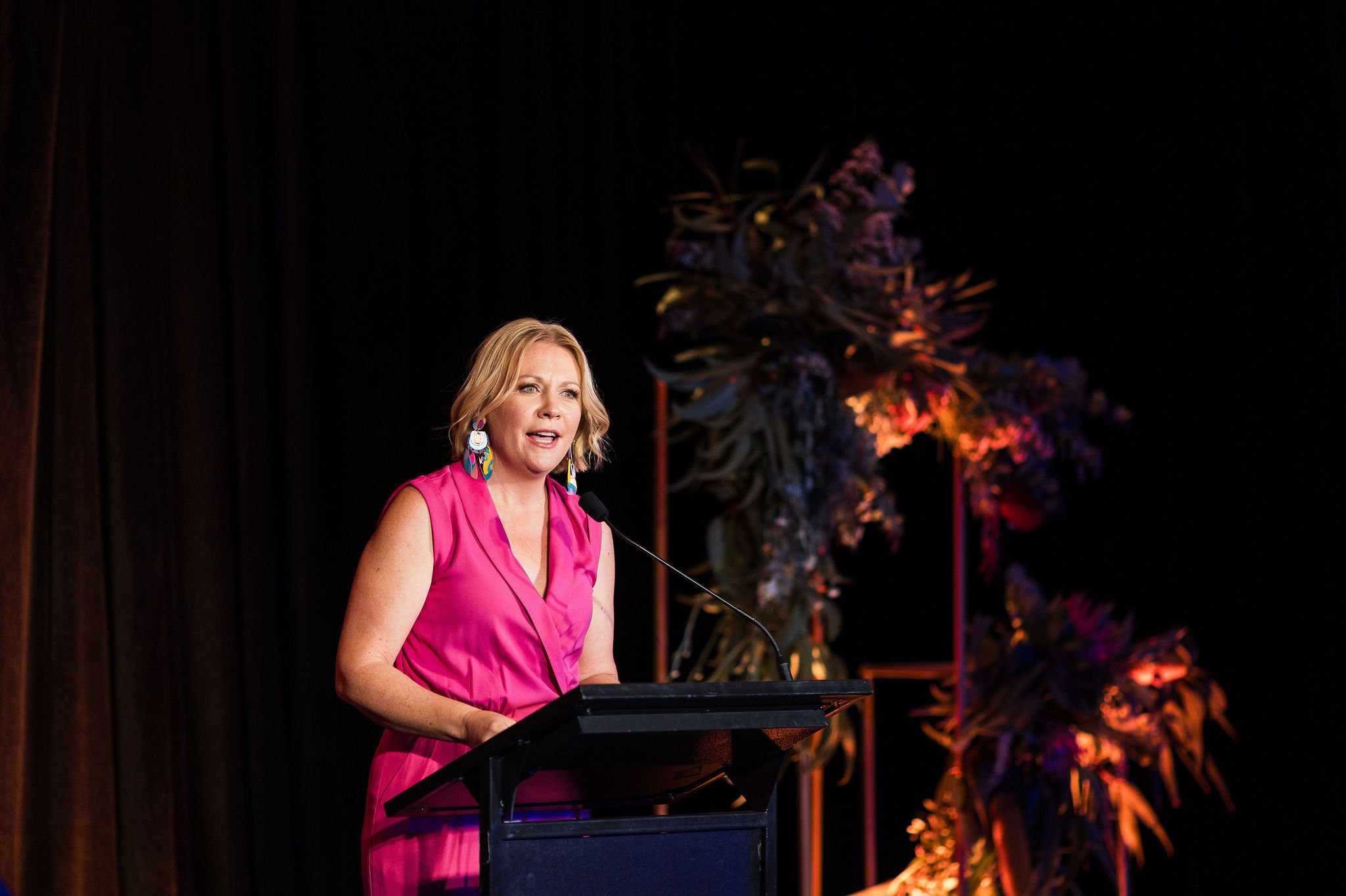 Event photography Canberra - woman speaks on stage