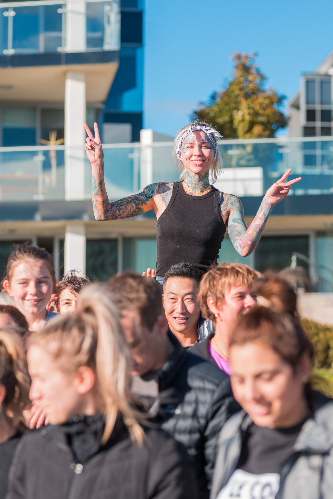 Canberra Event Photography - Woman on friends shoulders poses for camera
