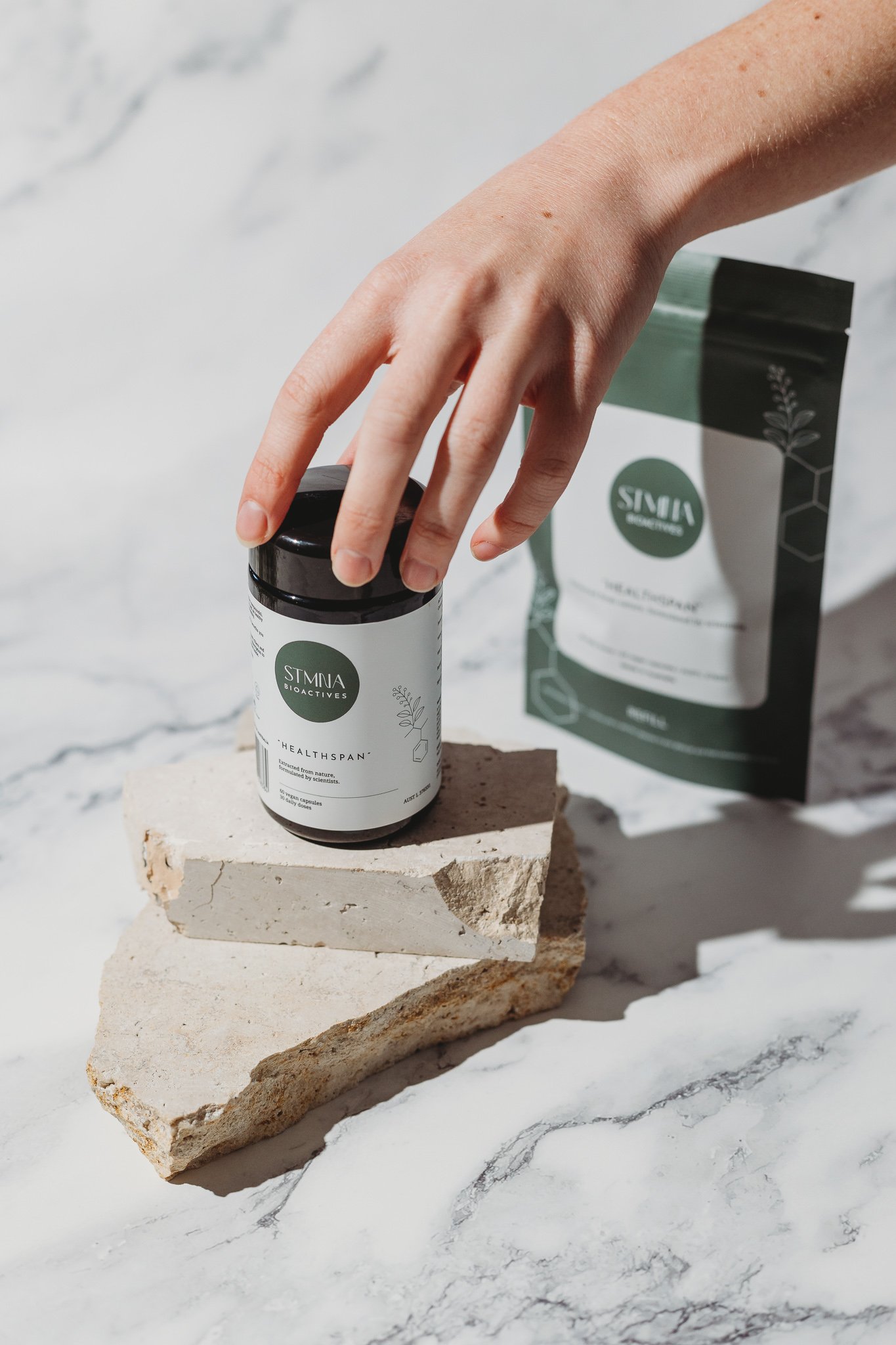 Canberra product photographer - hand reaches for vitamins
