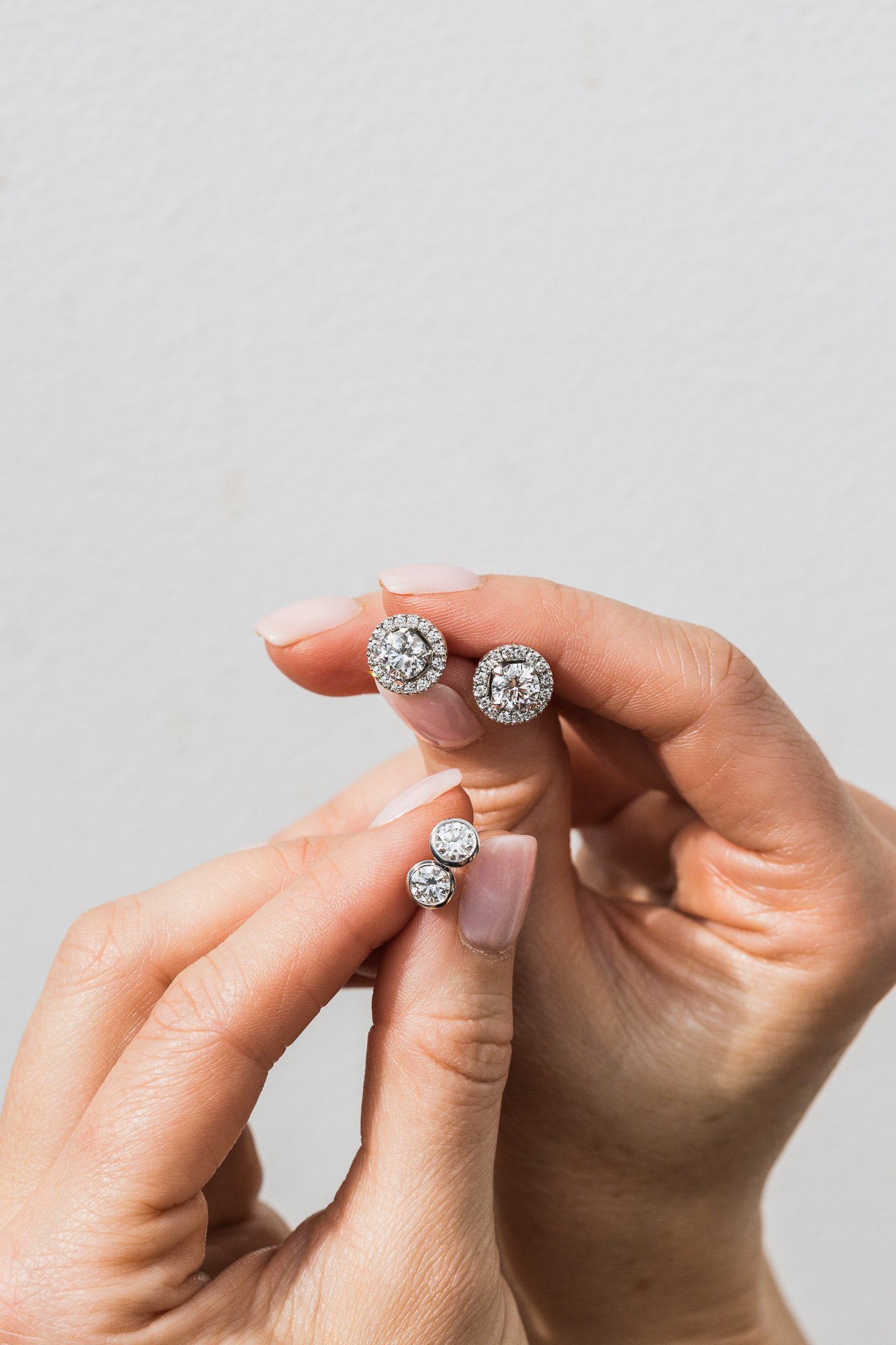 Canberra product photography - hands hold diamond earrings