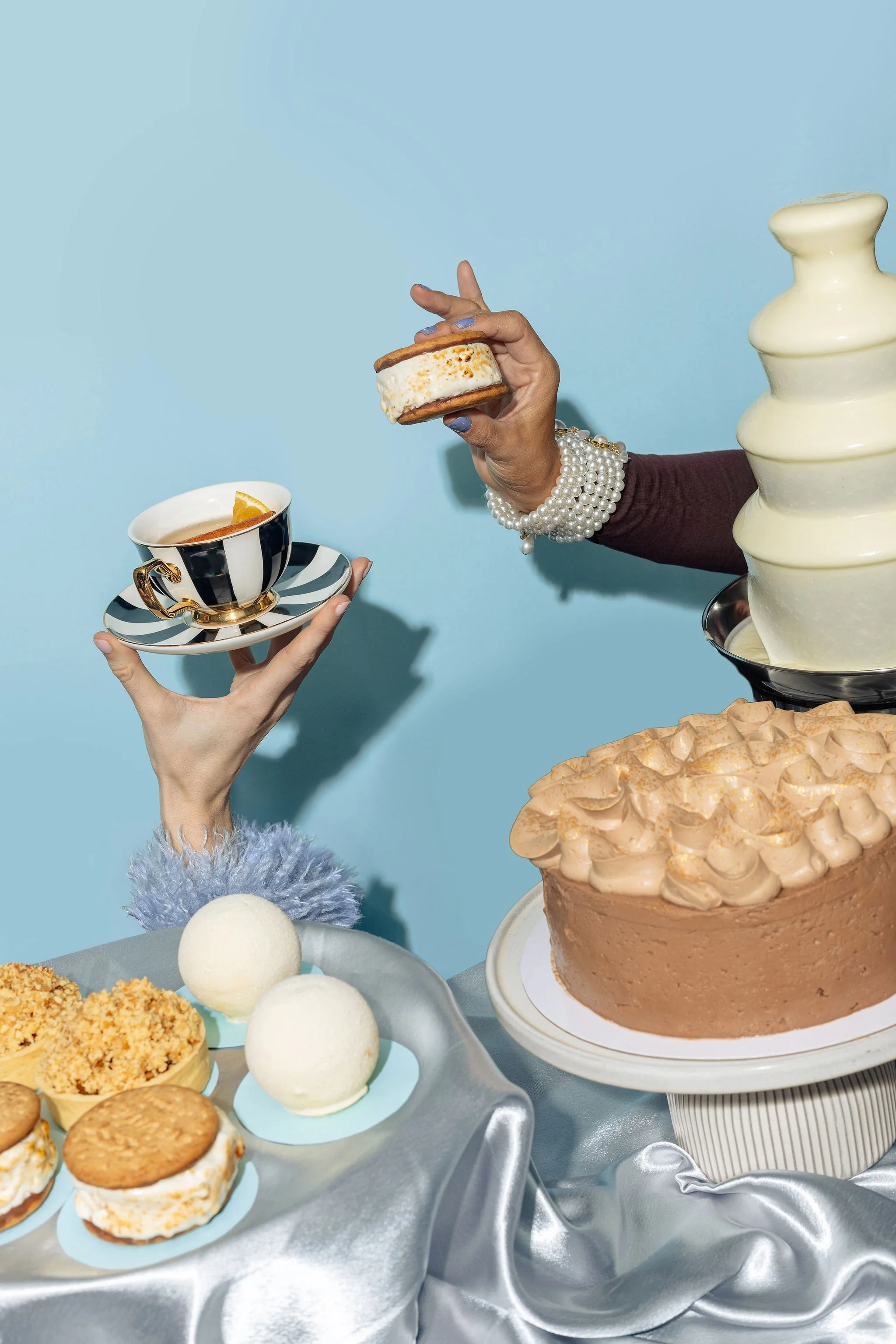 Canberra food photographer - hands hold teacup and cakes
