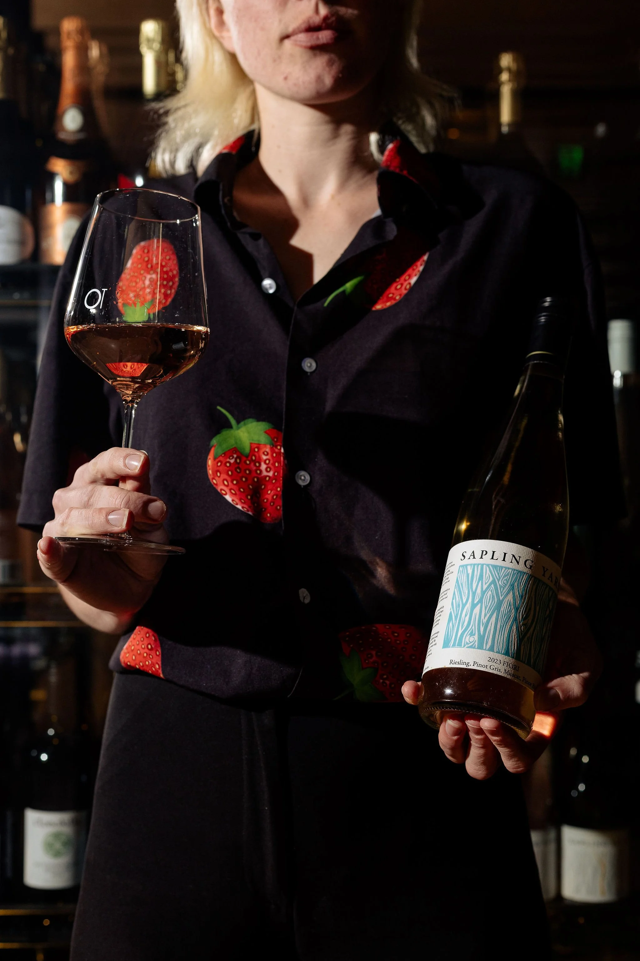 Canberra food photography - woman holds wine bottle and glass