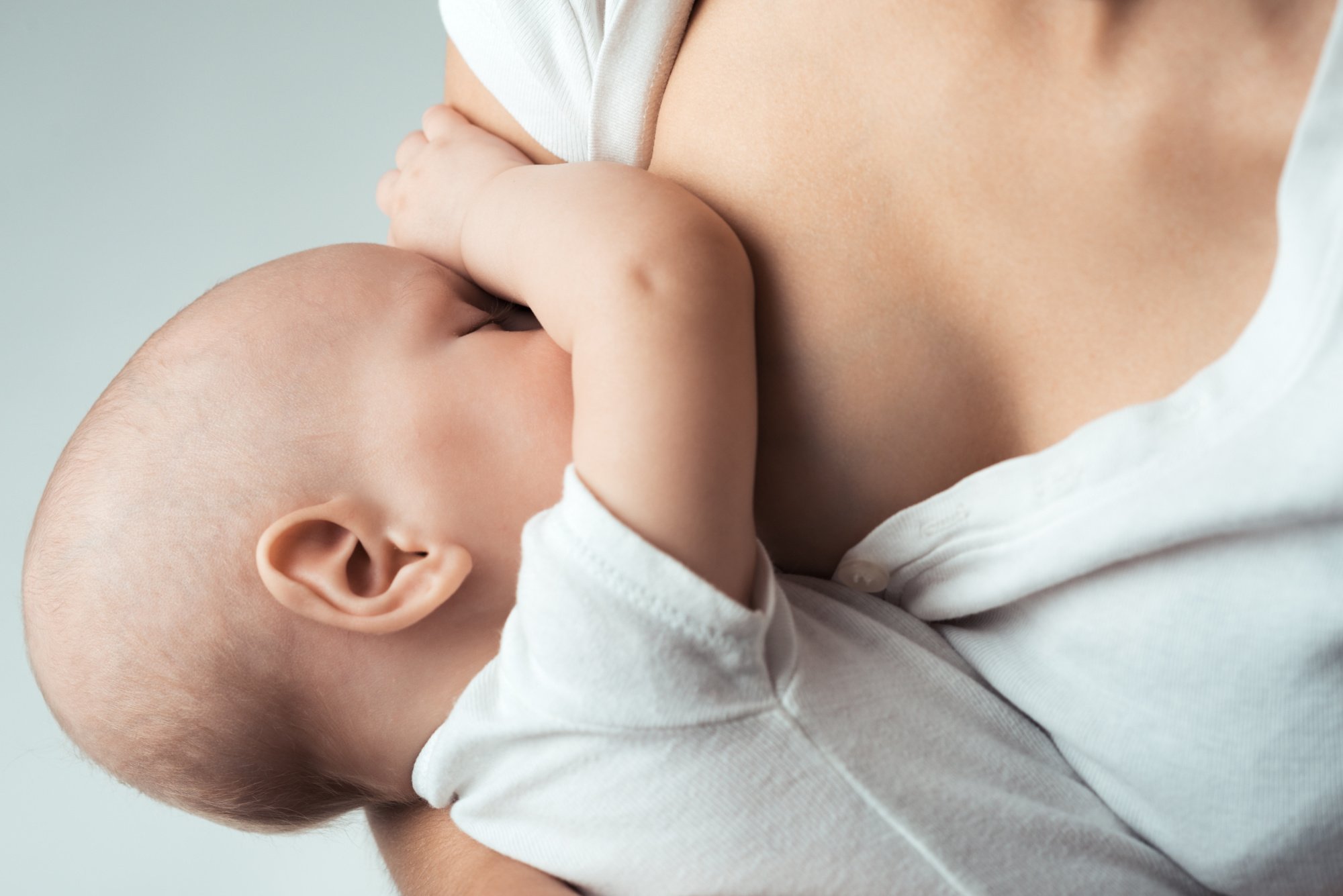 Baby wearing white being breastfed by Mum wearing white shirt_PBB.jpg
