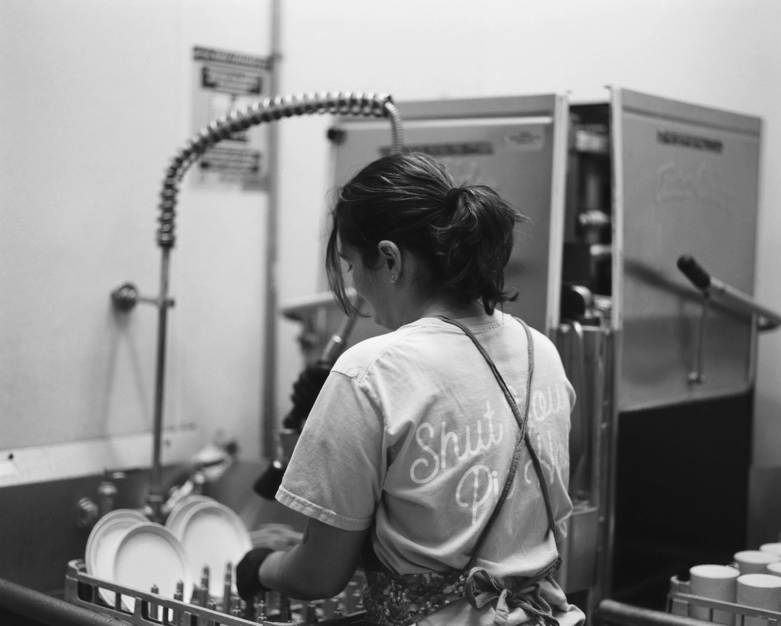 Juniper doing the dishes during shift exchange at the shop