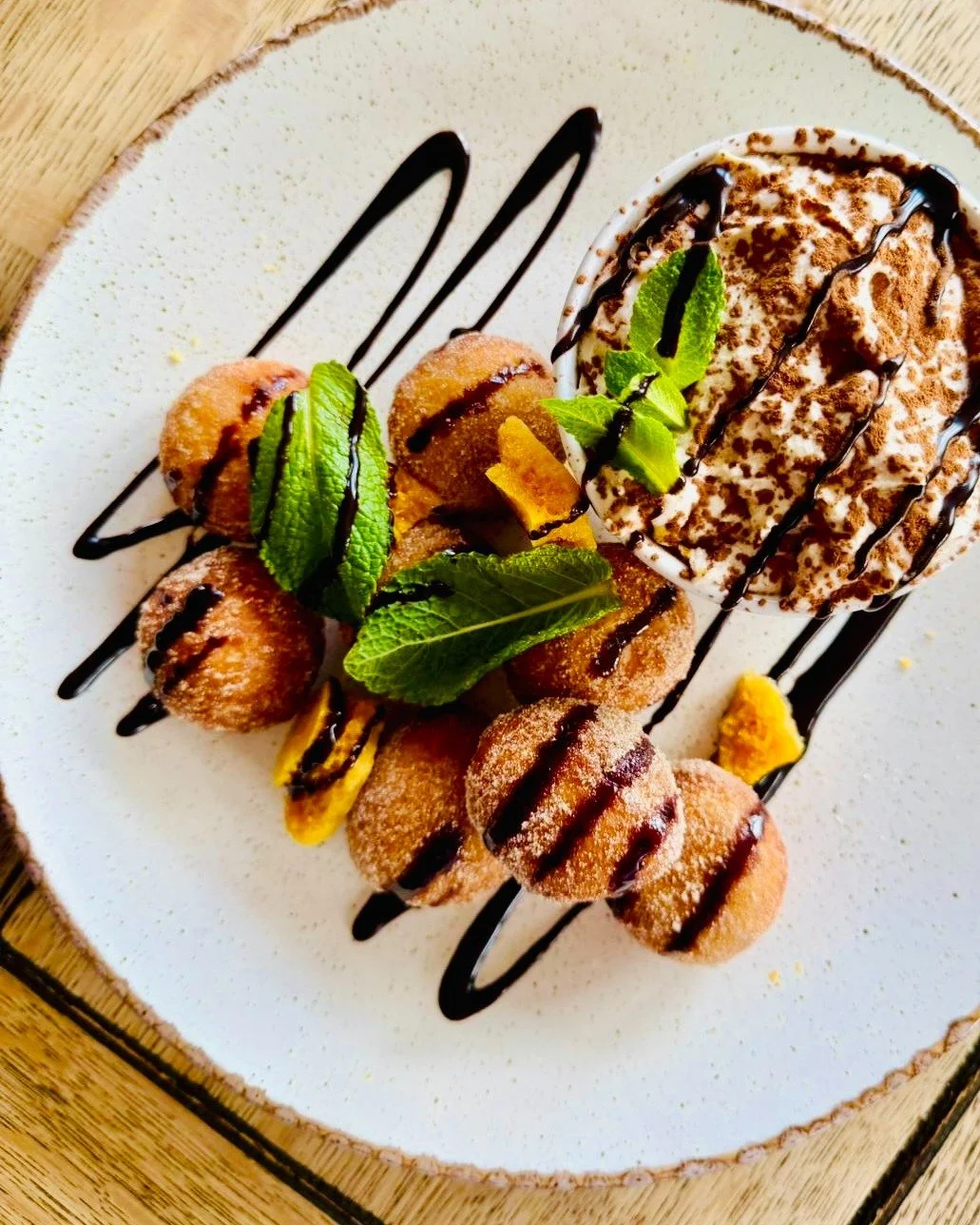 Coffee &amp; Donuts - Hot Homemade Cinnamon Donuts &amp; Cappuccino Mousse (V)

A warm, indulgent nod to a classic pairing, reimagined for long spring evenings and slow summer nights. Fresh, hot cinnamon donuts arrive straight from the kitchen, soft 