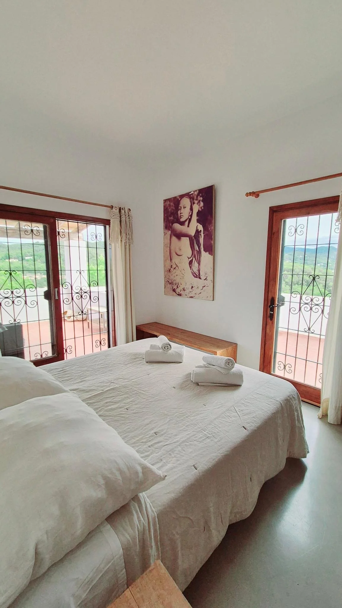 Cozy light-filled Ibiza retreat villa lounge and serene bedroom in Ibiza style with mountain and sea view designed for embodied rest and sensory connection