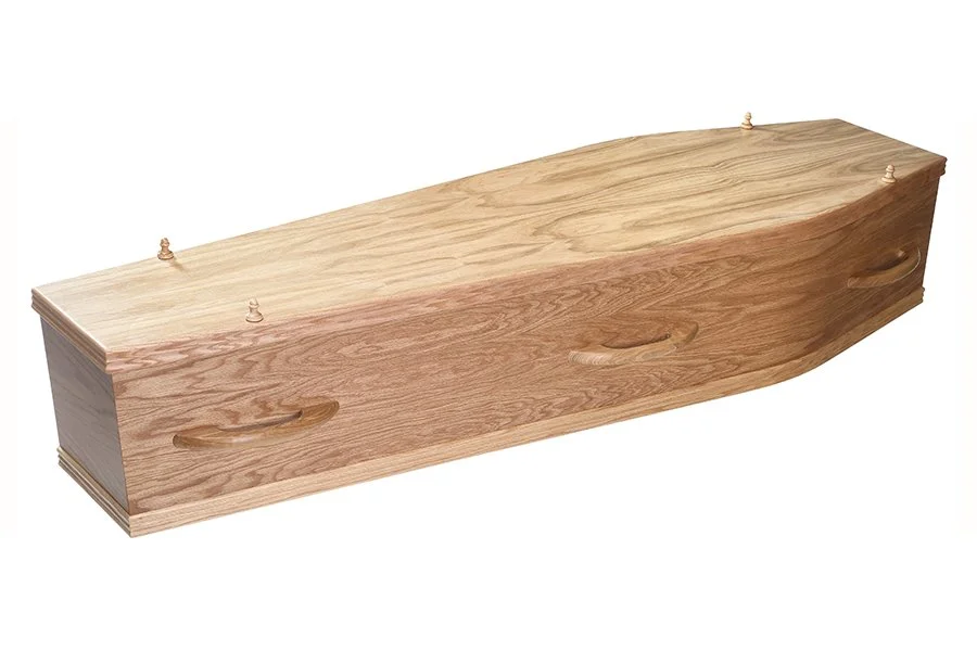 A wood veneer coffin with a natural finish.