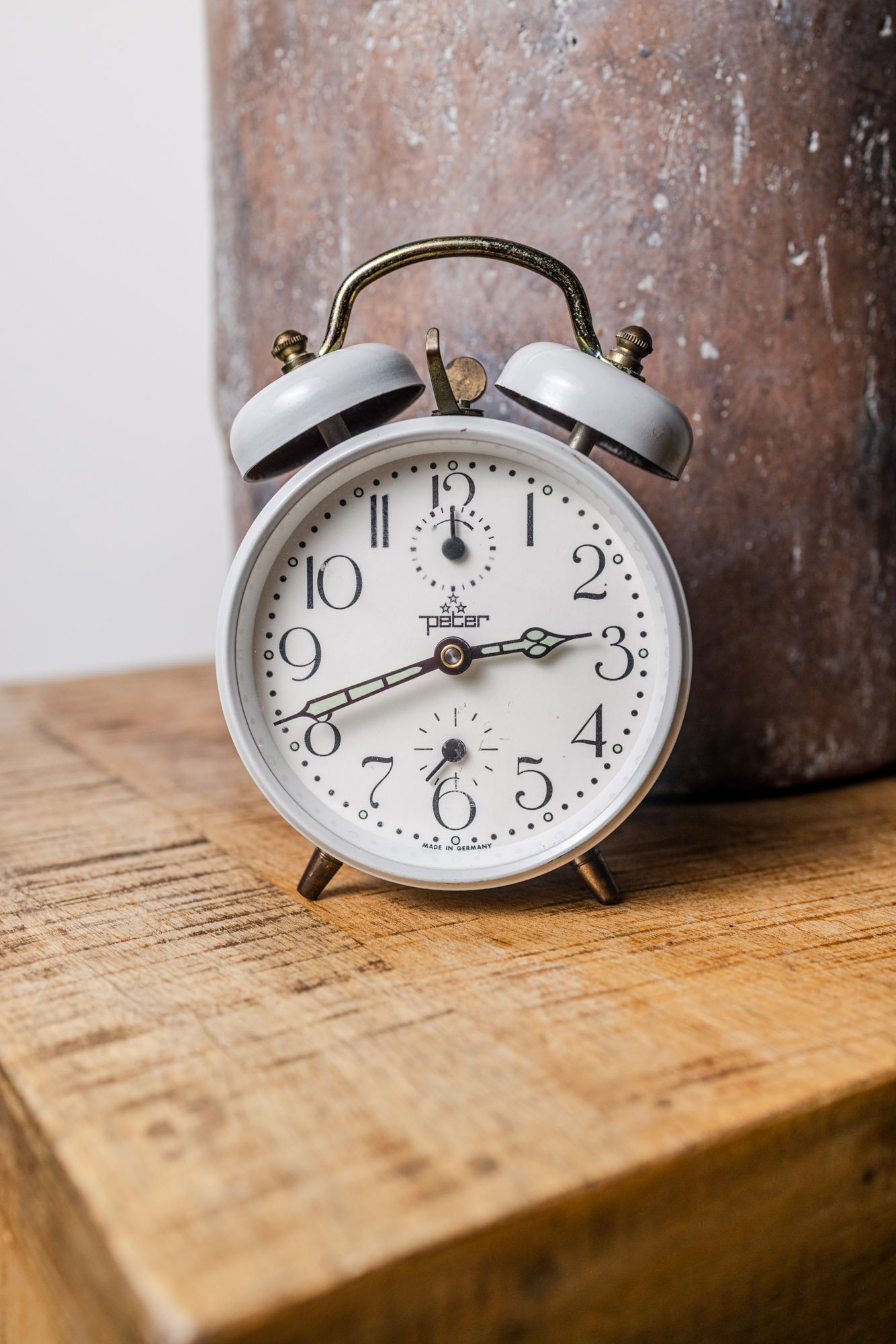 vintage peter alarm clock product photography rustic wooden table