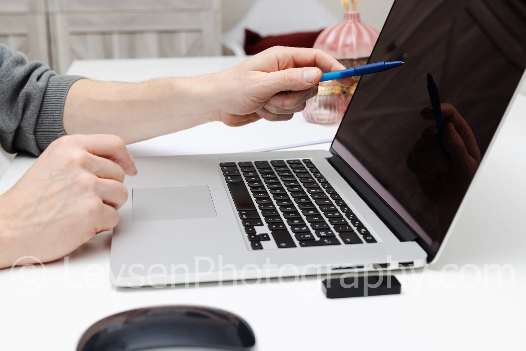 Laptop Workspace With Hand And Pen