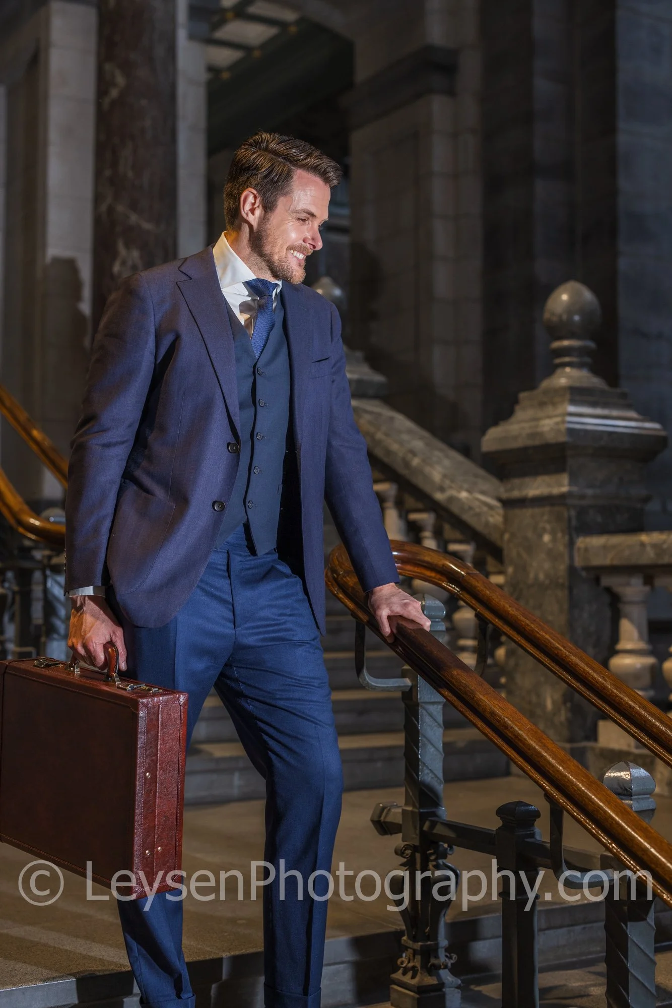 Confident Businessman Walking Down Stairs with Briefcase – Corporate Lifestyle Stock Photo