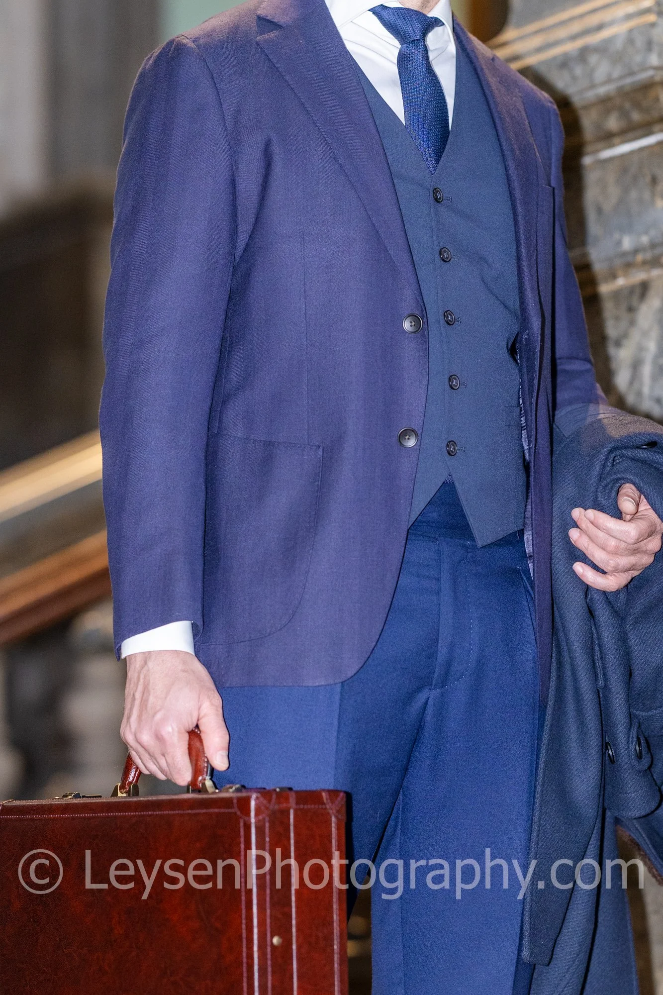 Business Suit Detail with Leather Briefcase in Corporate Setting