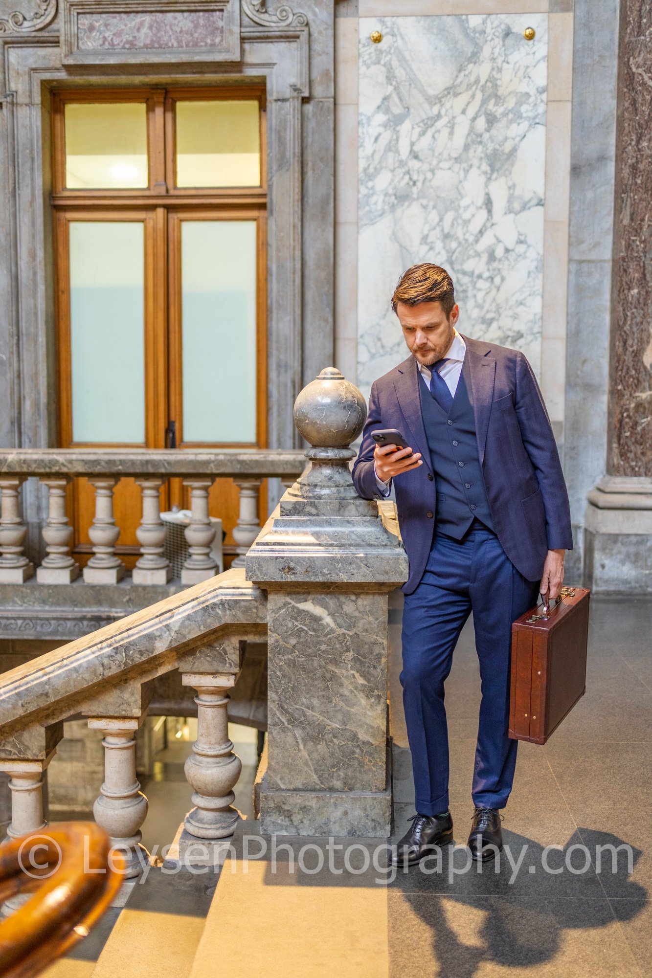 Executive Businessman Walking with Briefcase in Historic Architecture