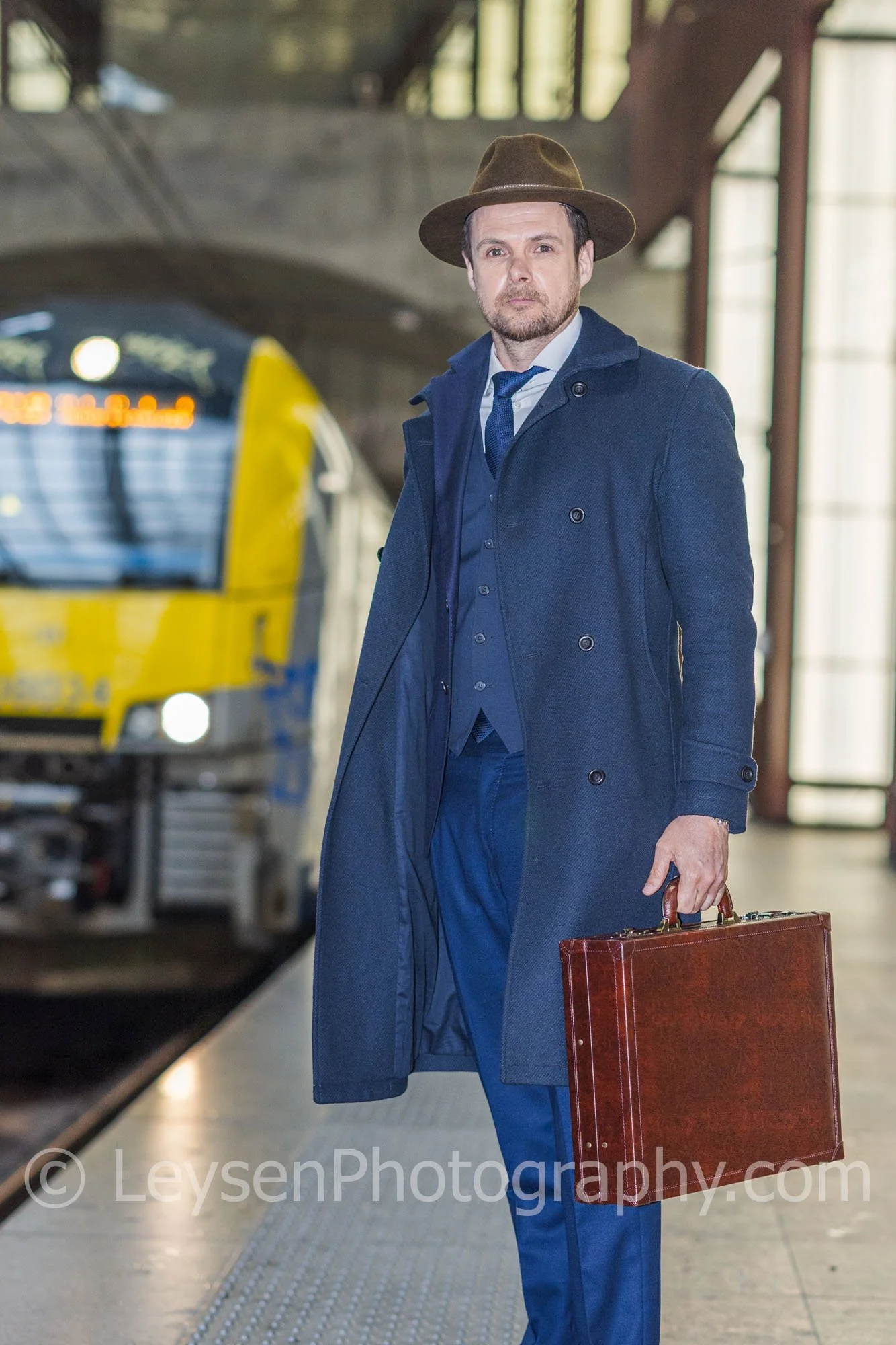 Confident Businessman with Suitcase at Train Station Platform