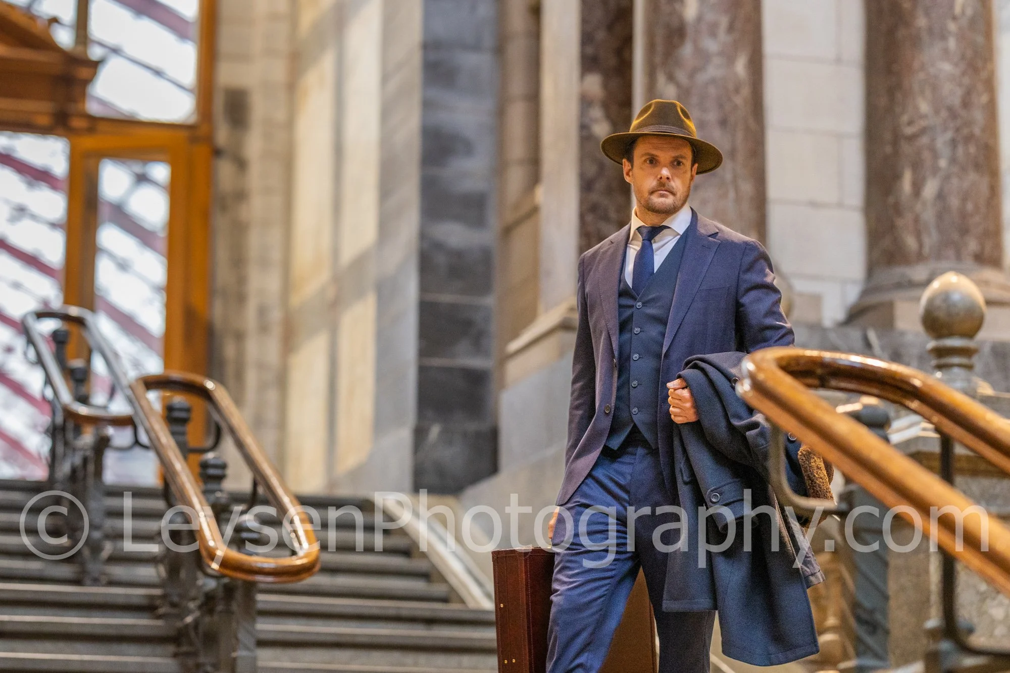 Elegant Businessman Walking Down Stairs with Briefcase