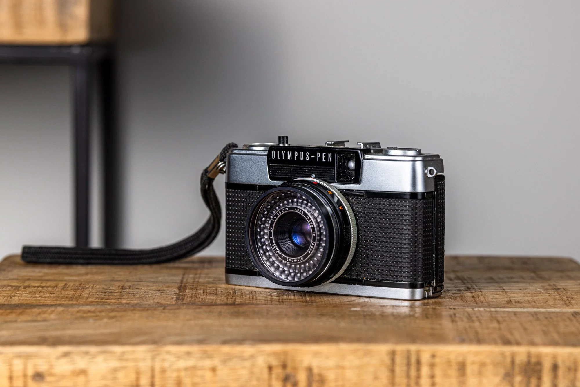 classic olympus pen vintage film camera on wooden table product photography