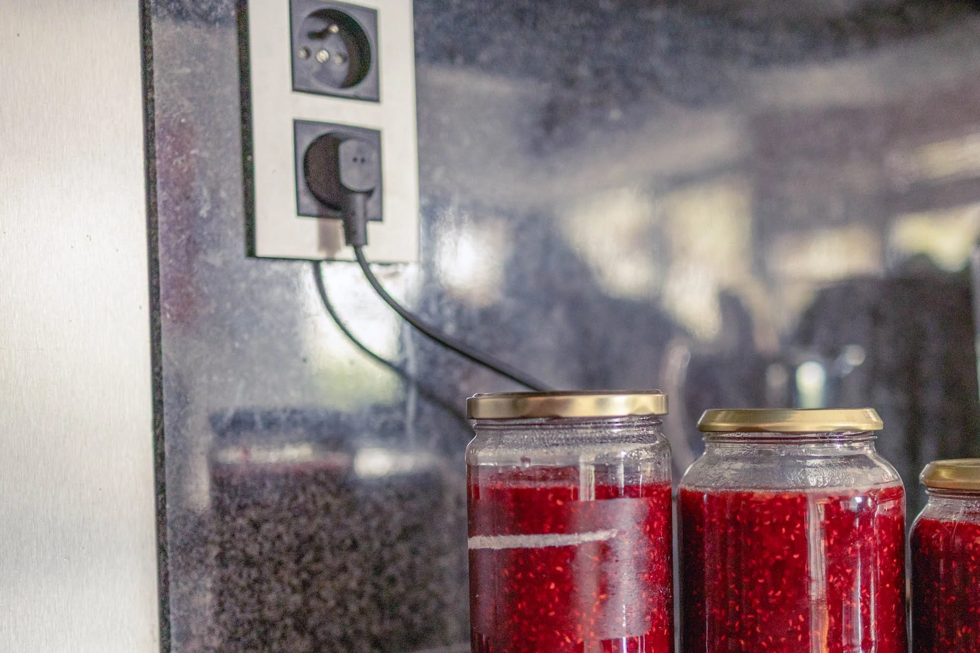 unprofessional product photo with messy composition, jars on a kitchen counter and distracting background elements