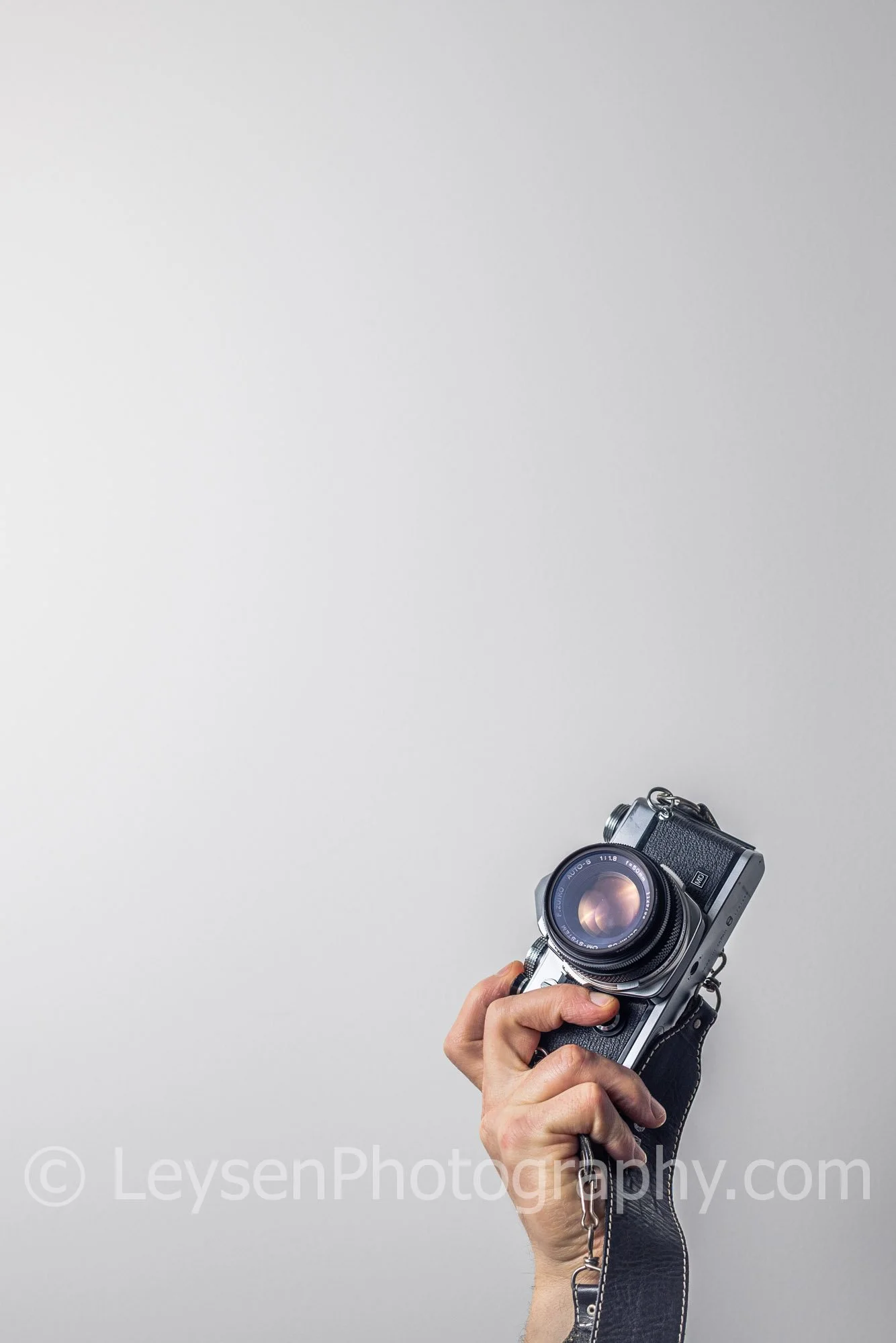 Hand Holding Vintage Camera with Negative Space
