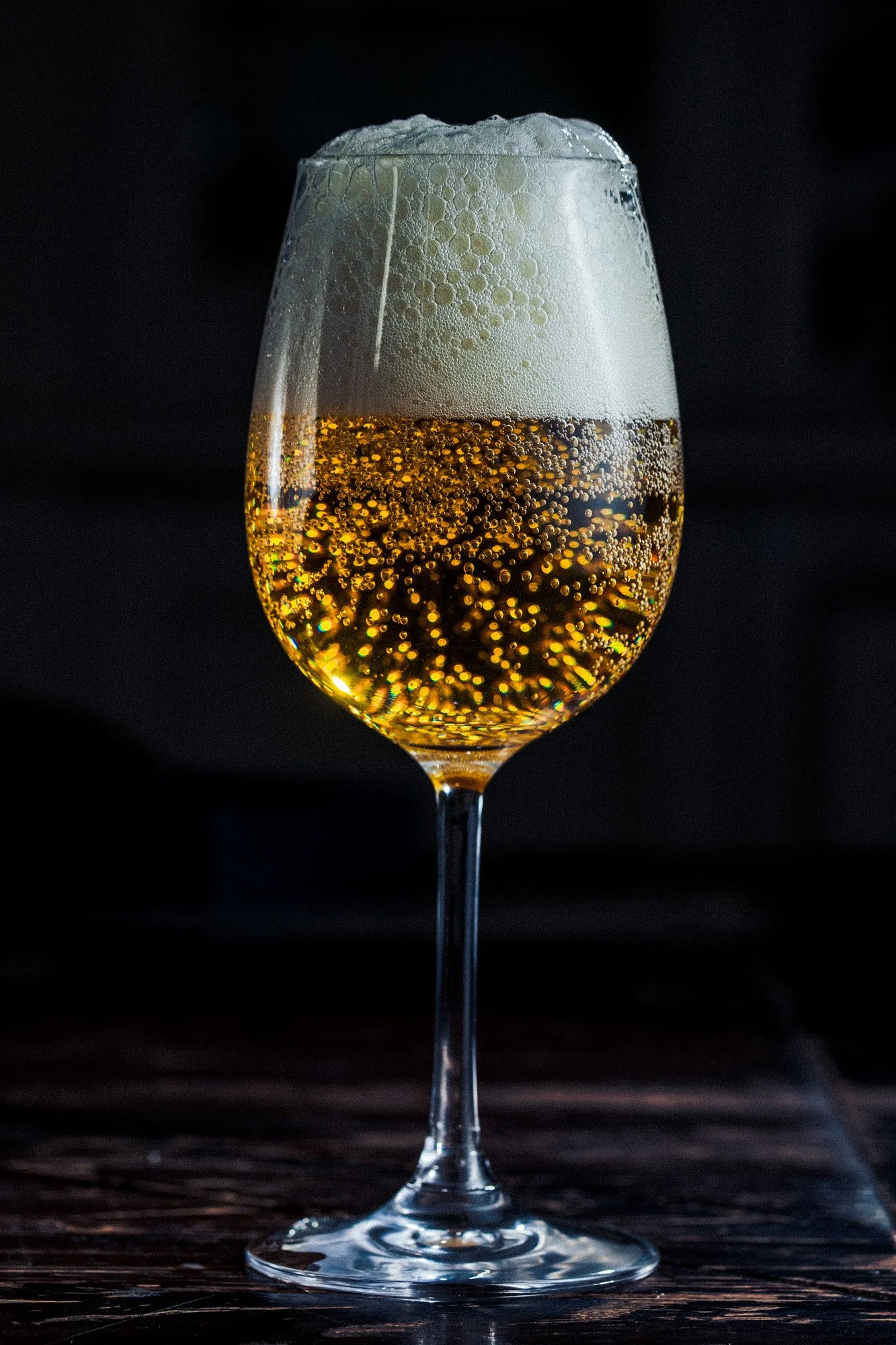 beer glass with foam bubbles drink product photography dark background