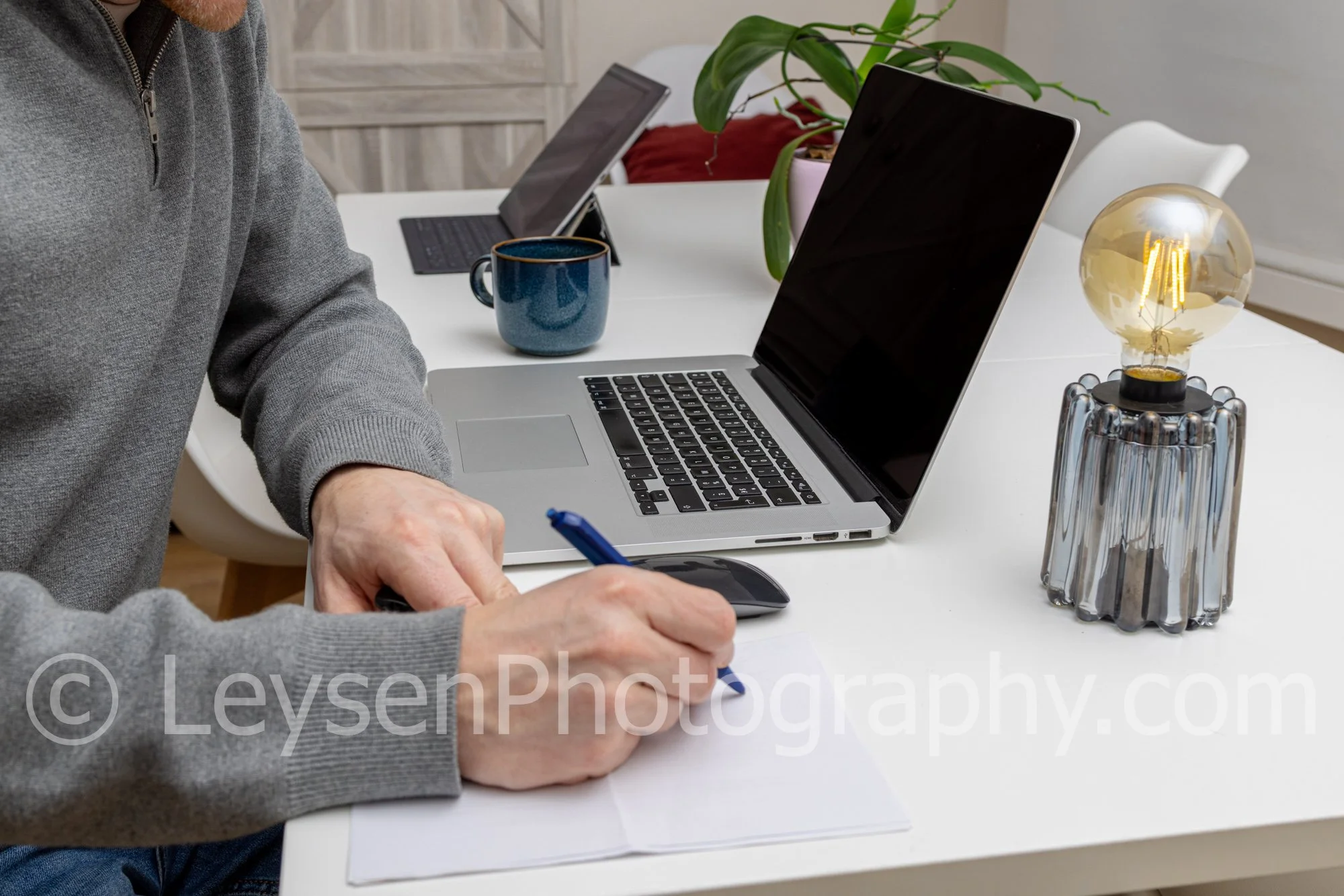 Writing Notes at Laptop Workspace – Productivity Desk Stock Photo