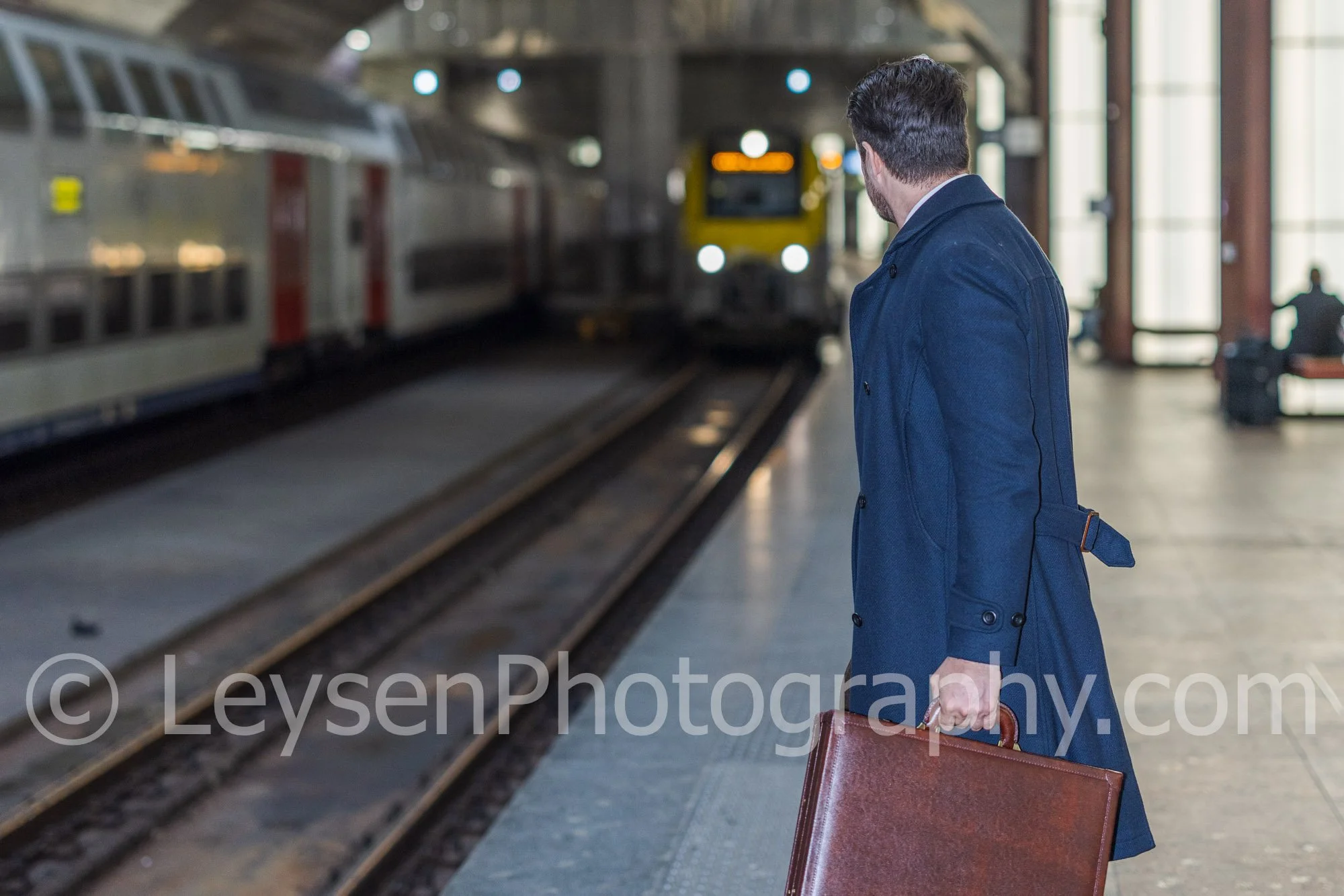 Confident Businessman with Suitcase at Train Station Platform