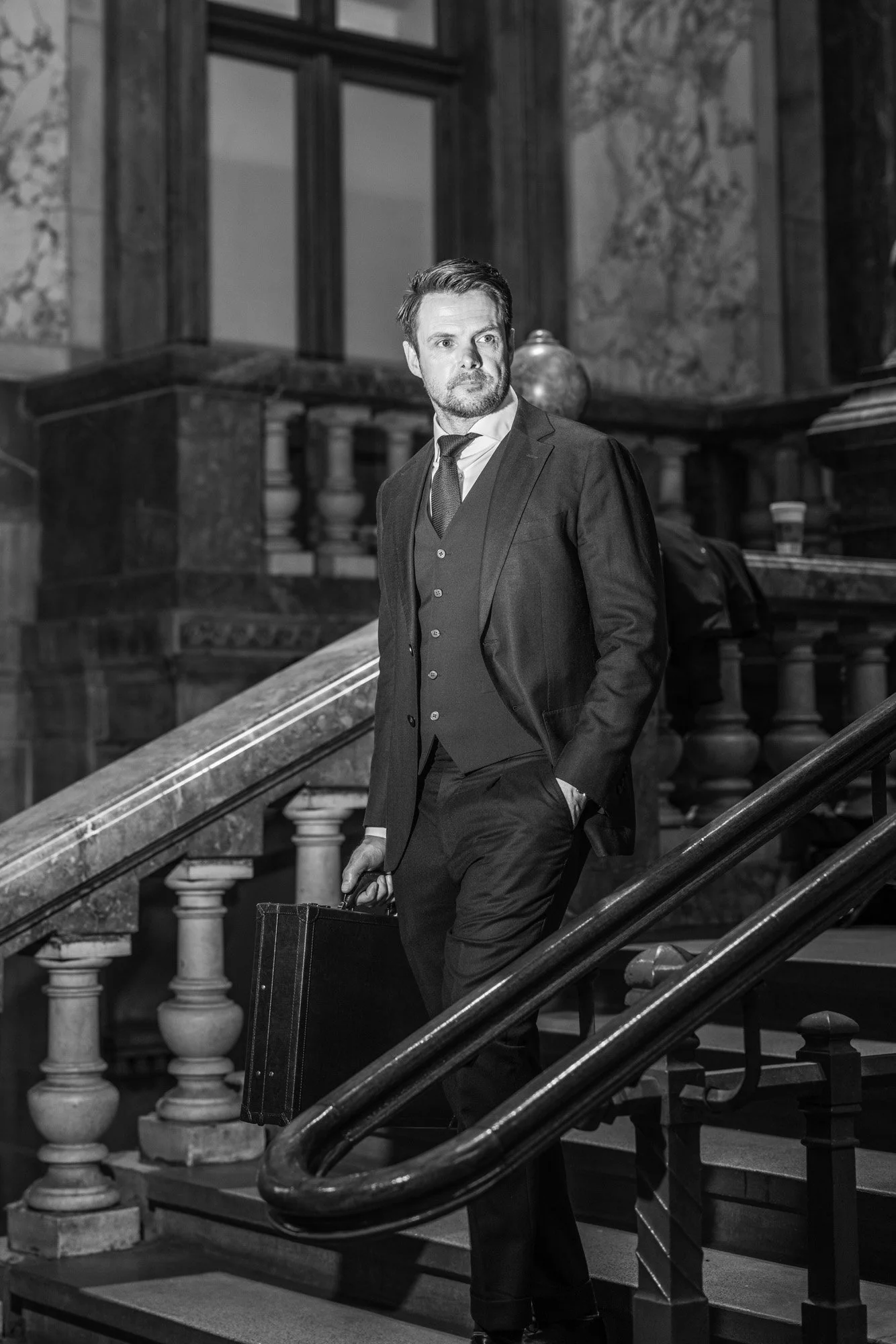 elegant businessman walking down stairs corporate branding portrait