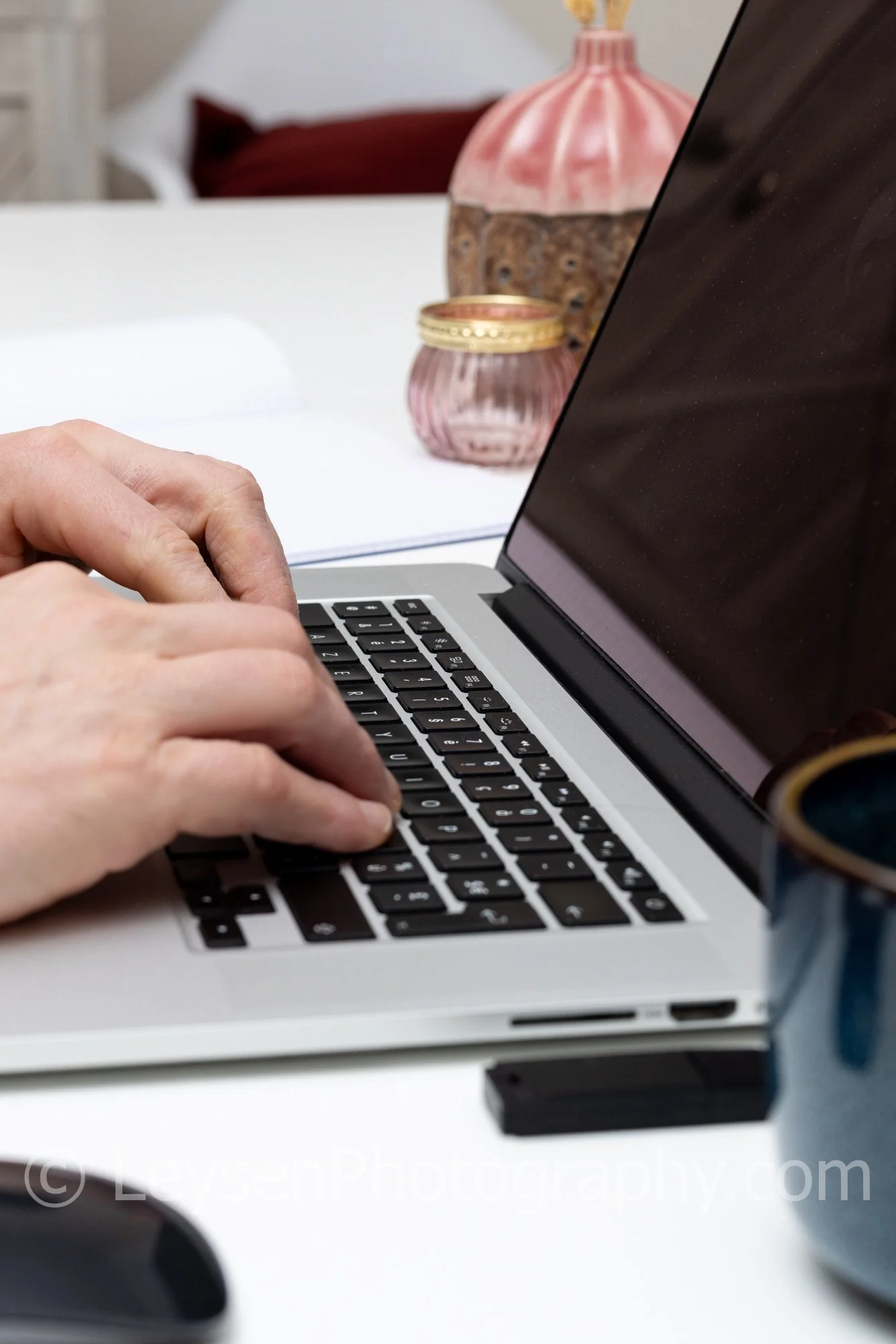 Typing On Laptop In Minimal Workspace