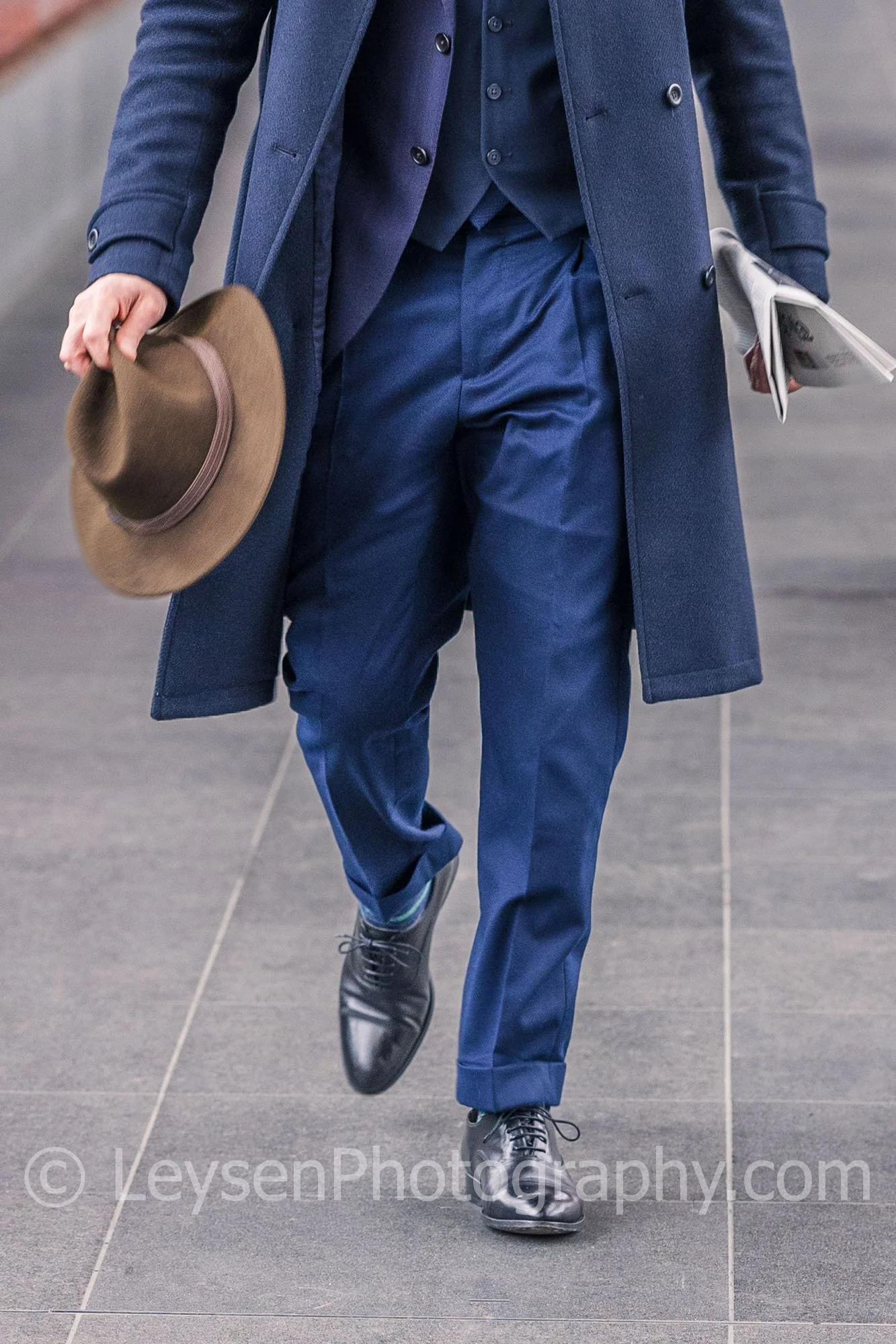 Elegant Businessman Walking Through Modern Red Steel Corridor