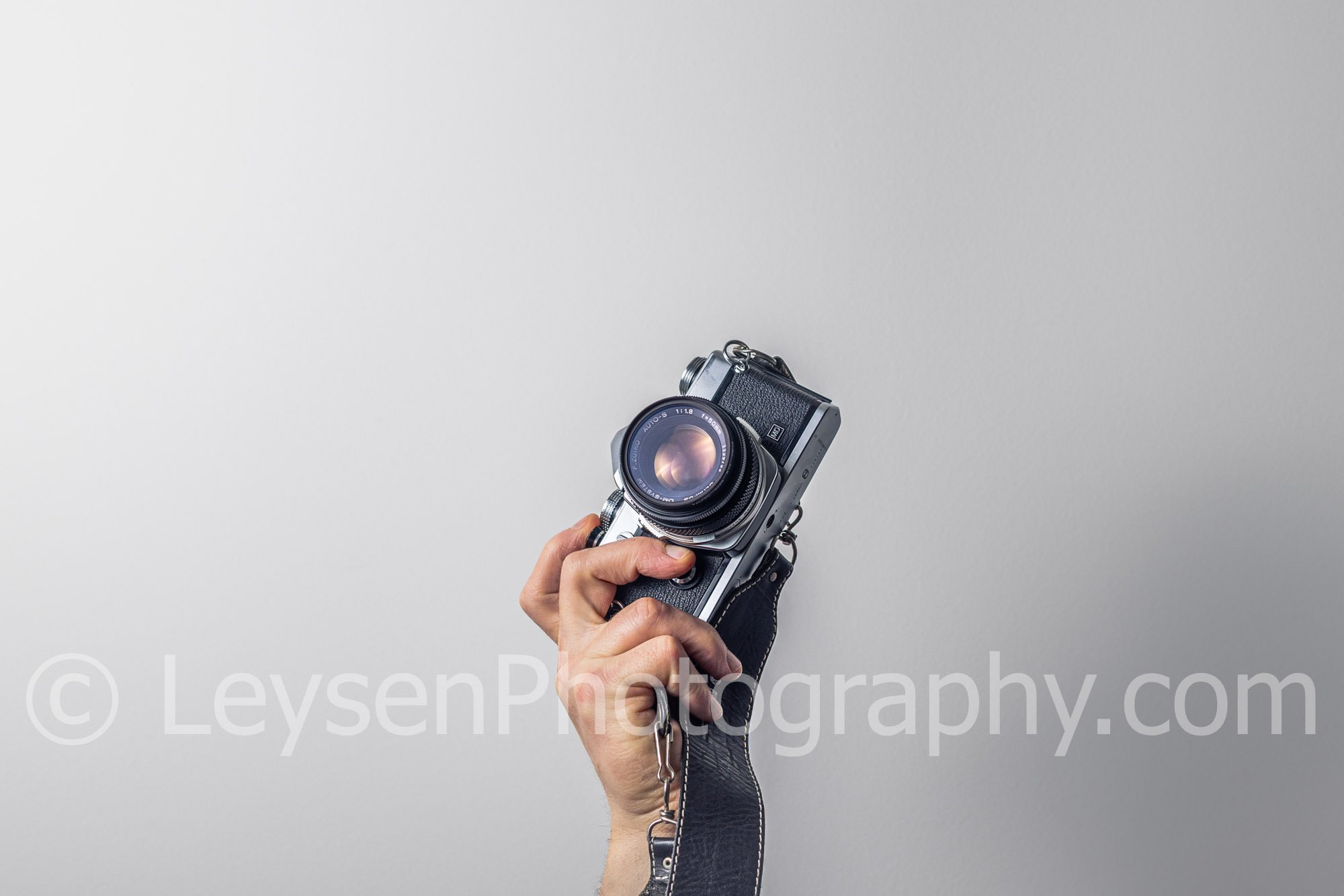 Hand - Camera - Retro - Olympus - negative space.jpg