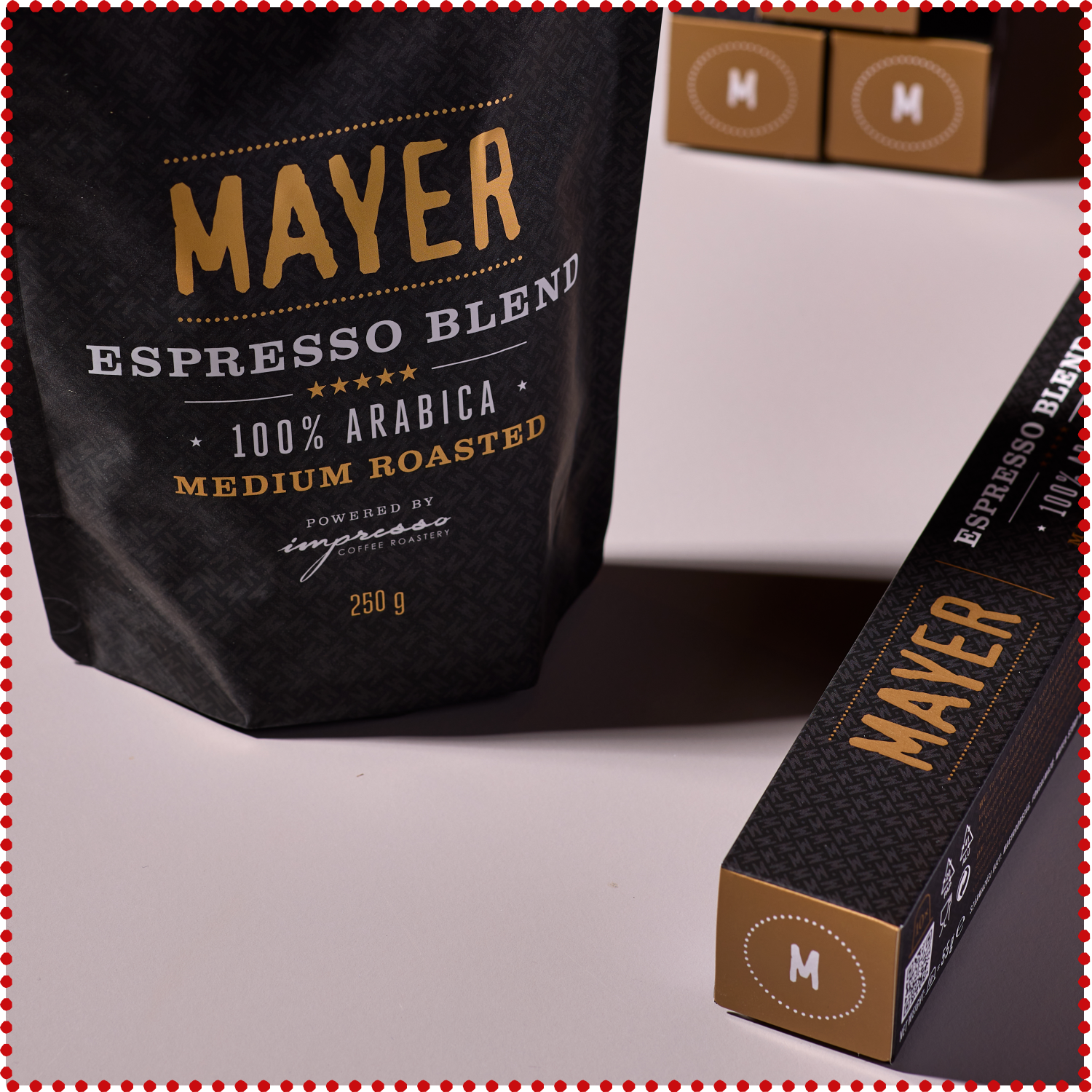 Pack of Mayer Espresso Blend coffee beans on a bed of whole coffee beans.