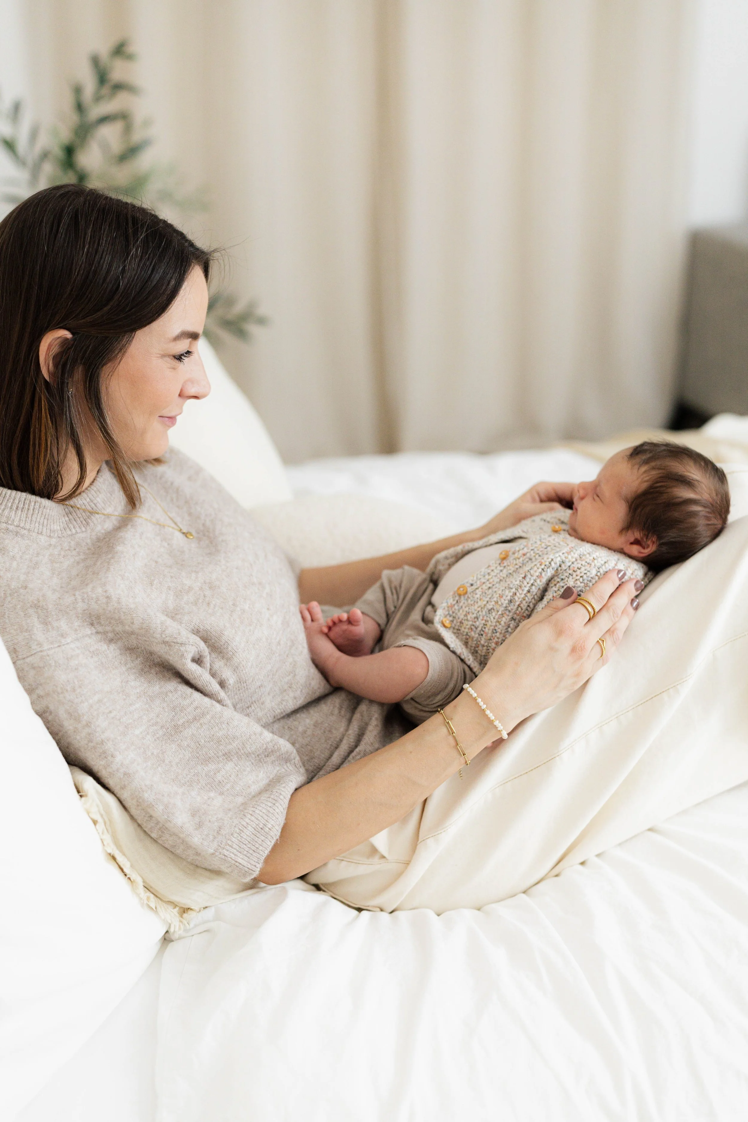 Mama und Newborn auf dem Bett im Studio 18 