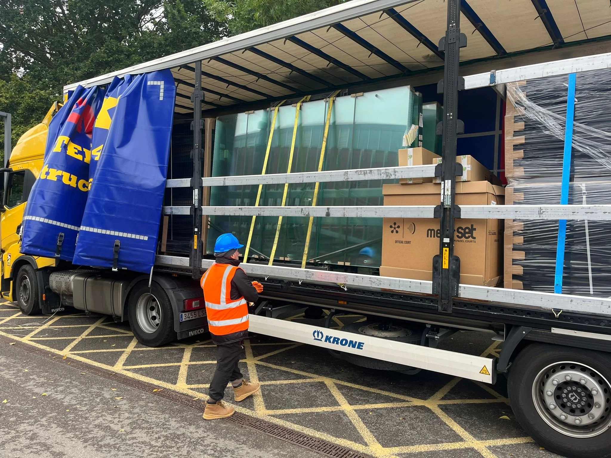 A Large Lorry with Padel Court materials. Glass, steel and sand ready for unload at a UK Site