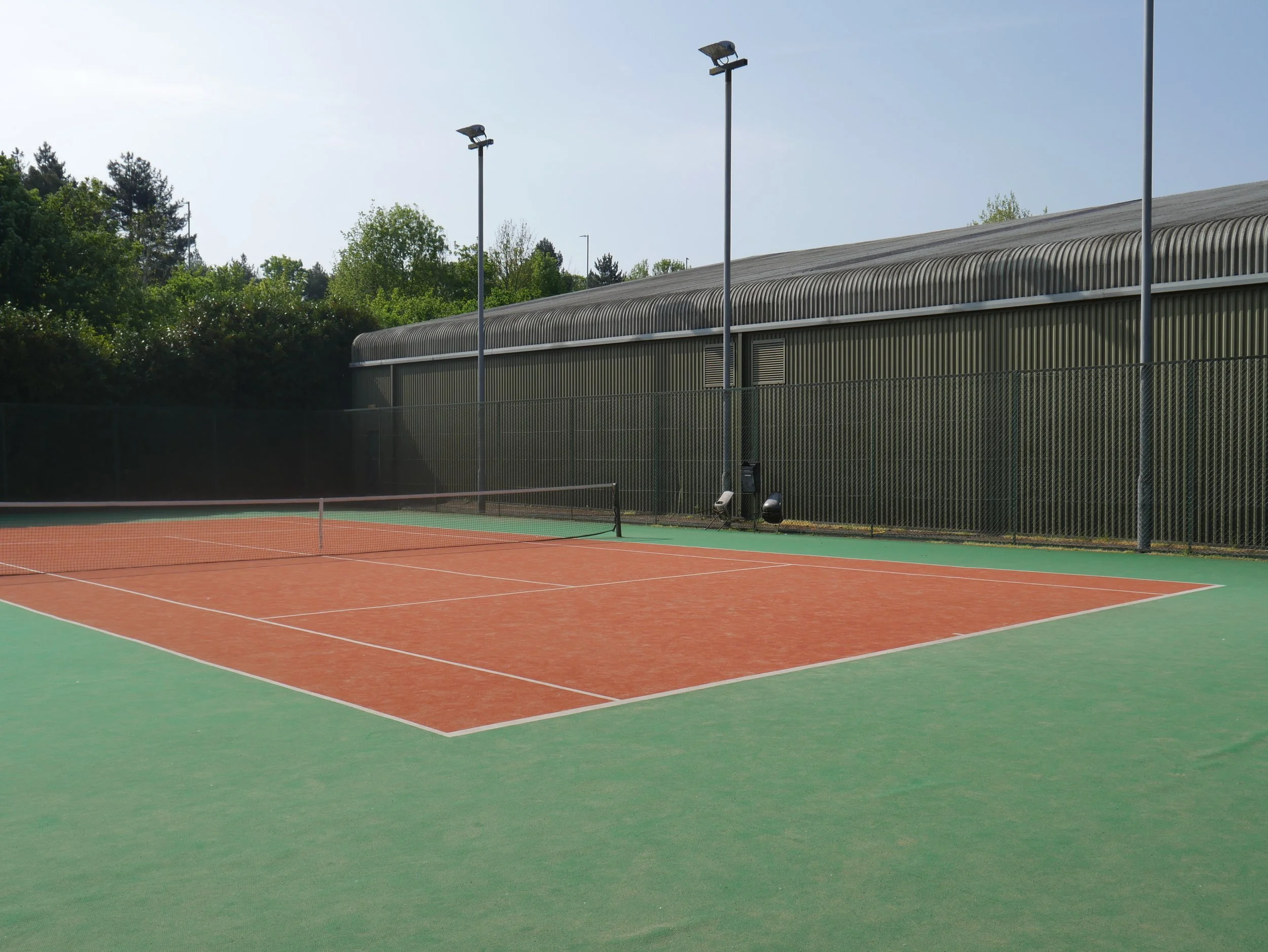 Empty outdoor tennis court before it was converted into Padel