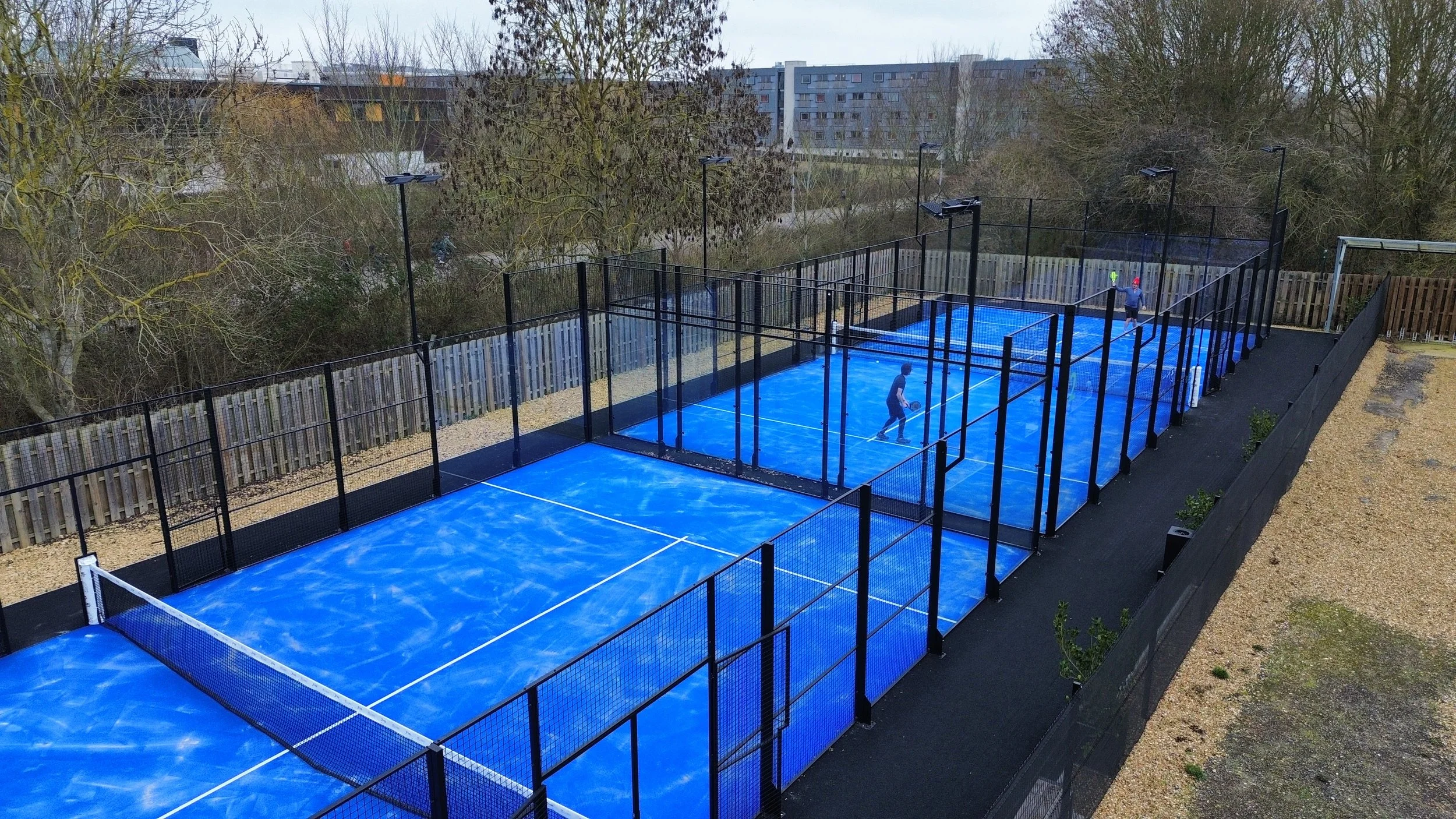 Two people playing Padel on the Courts at the University of Cambridge. UK Best Padel Courts MejorSet.
