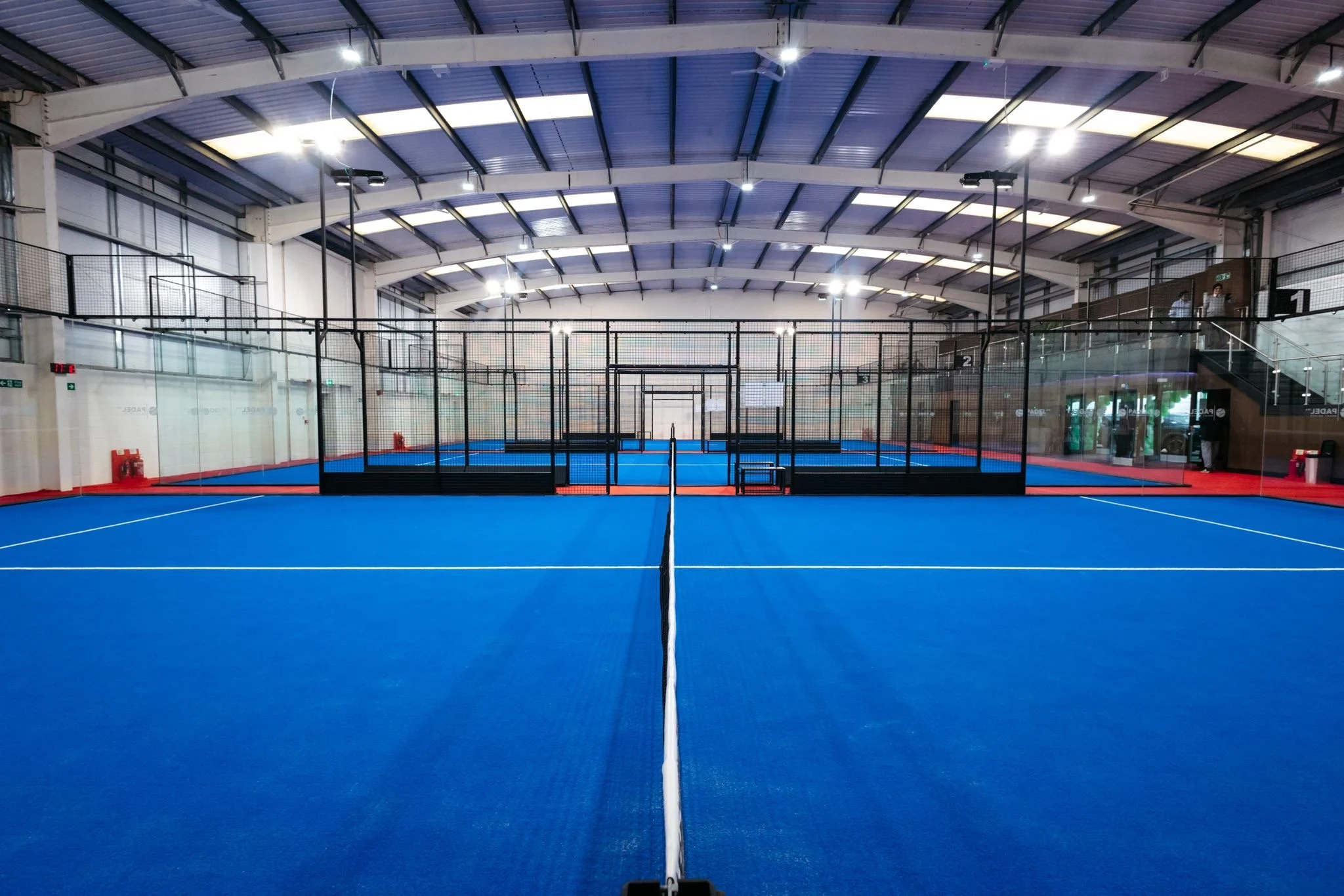 Indoor padel tennis court with a blue playing surface England's Best Padel Courts