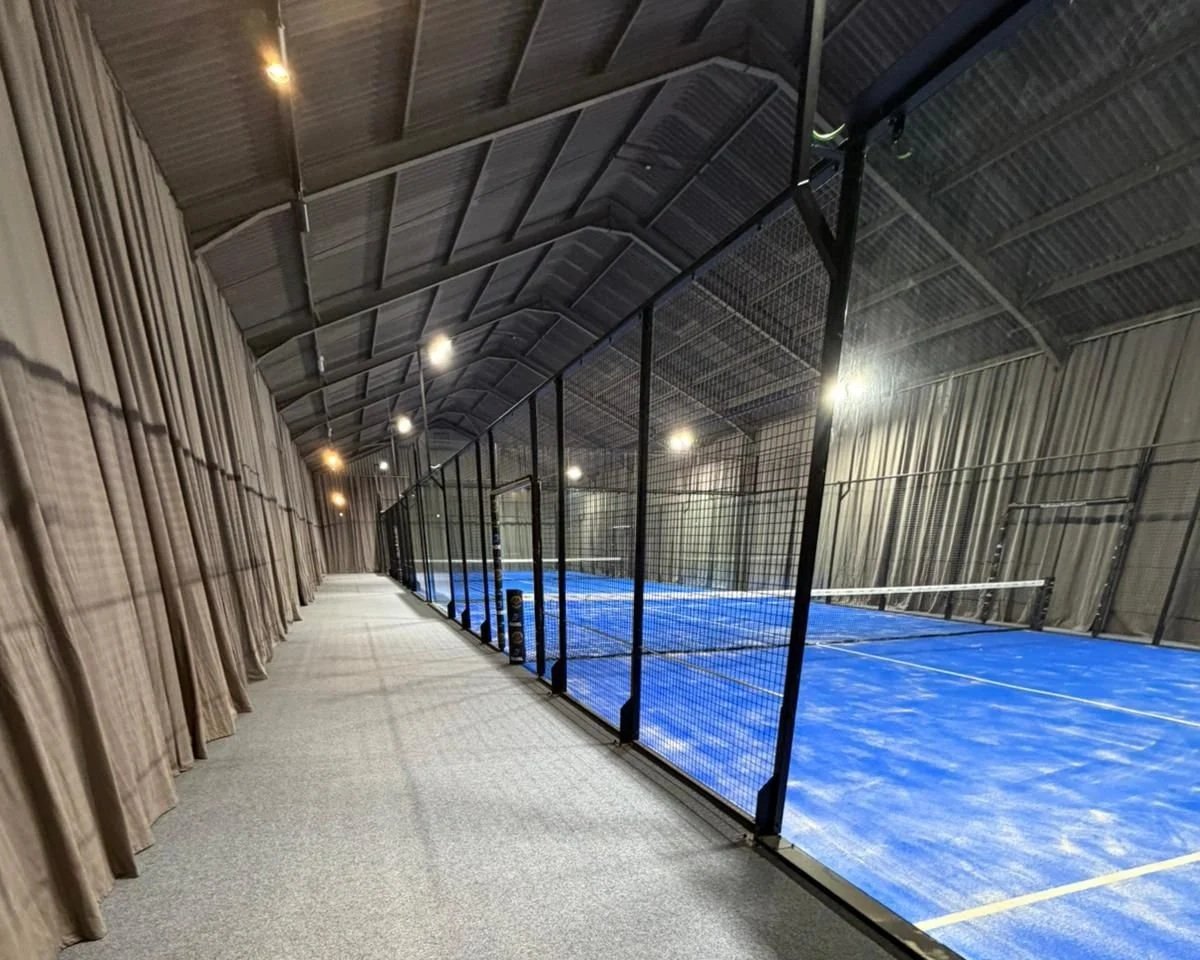 Indoor MejorSet Padel Courts in the UK with grey acoustic curtains. Podington Padel