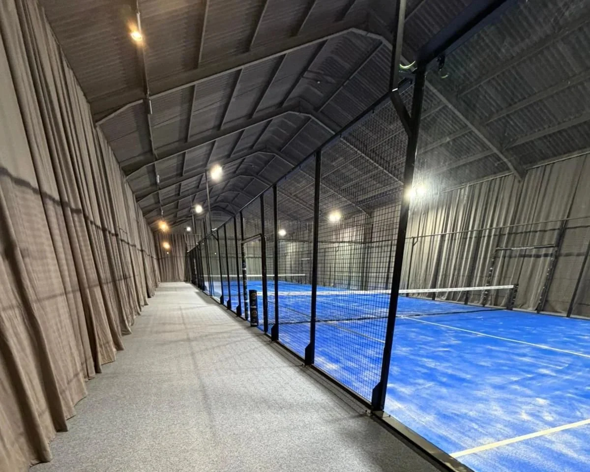 Indoor MejorSet Padel Courts in the UK with grey acoustic curtains. Podington Padel