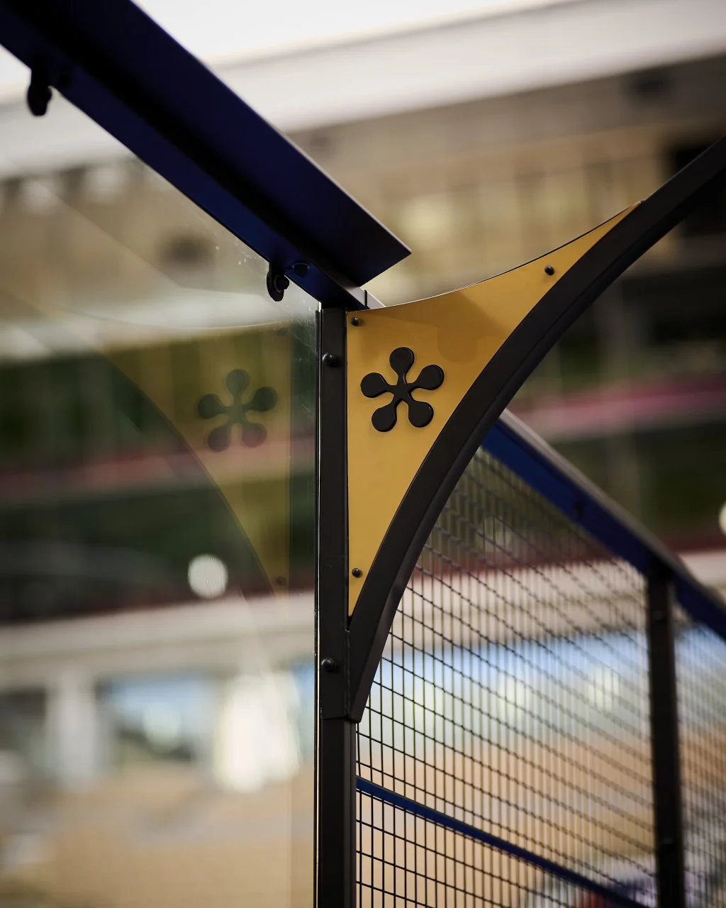 Close-up of the Premier Padel logo attached to the frame of a Black and Gold Premier Padel Court