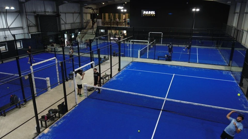 Indoor padel tennis courts in the UK with players practicing