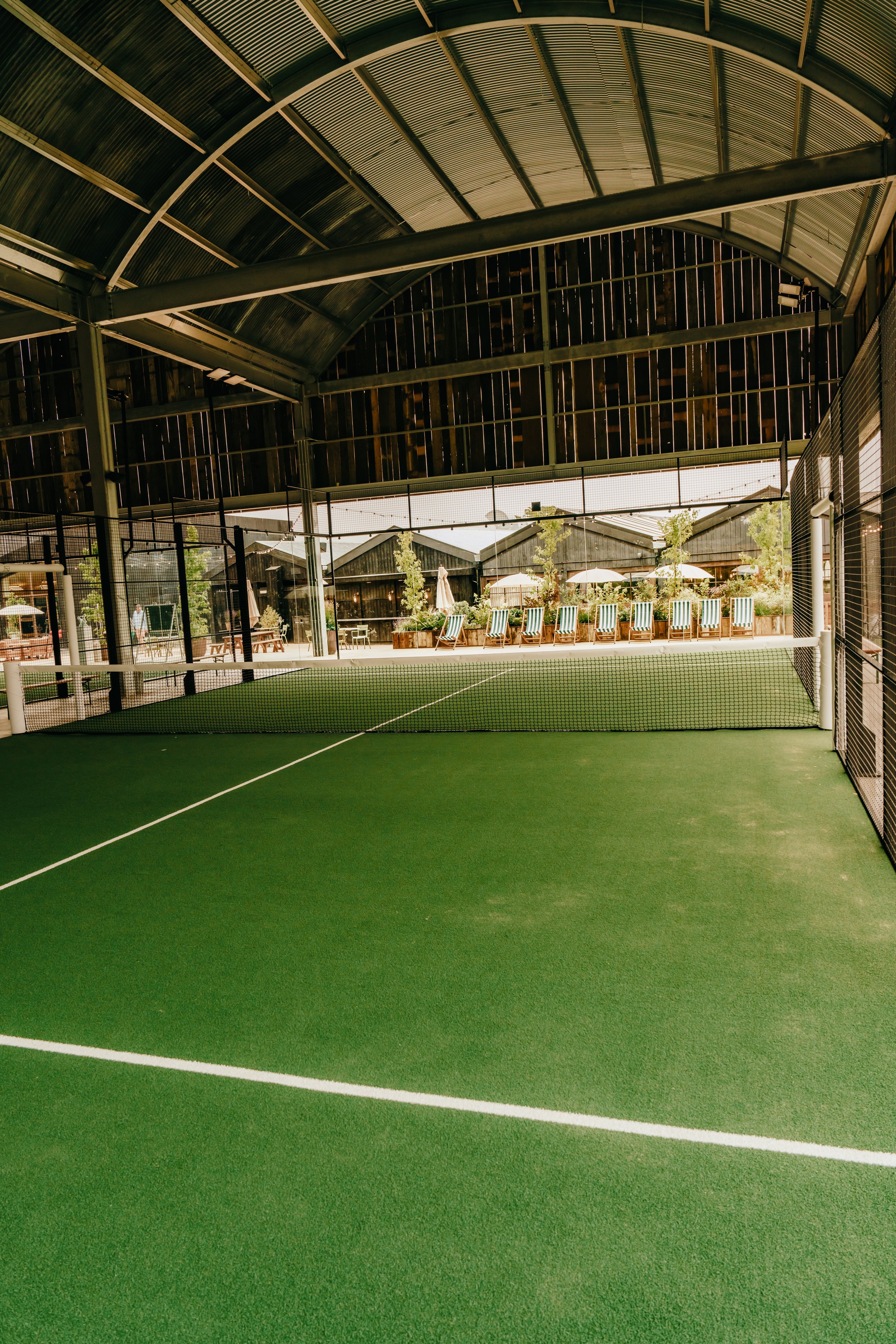 Padel Court at Soho Farmhouse. Underneath a bespoke canopy with Green turf.