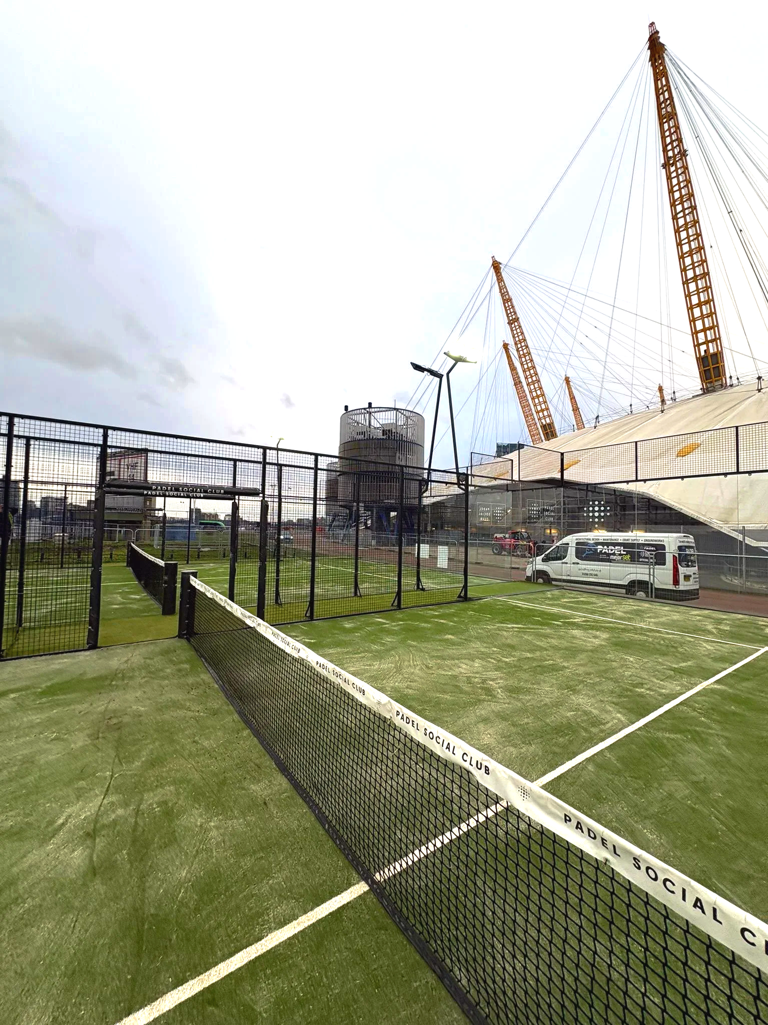 Padel Courts at the O2 Arena in London with green turf and the O2 in the Background