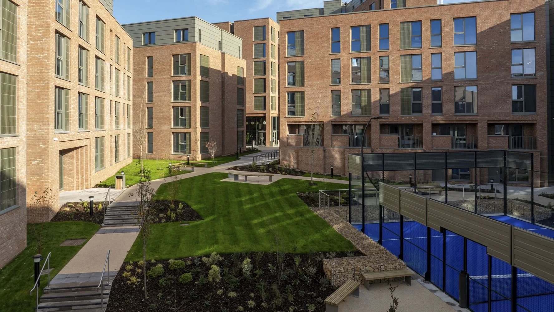 Student accommodation with an outdoor MejorSet Padel Court and sound proof barriers.