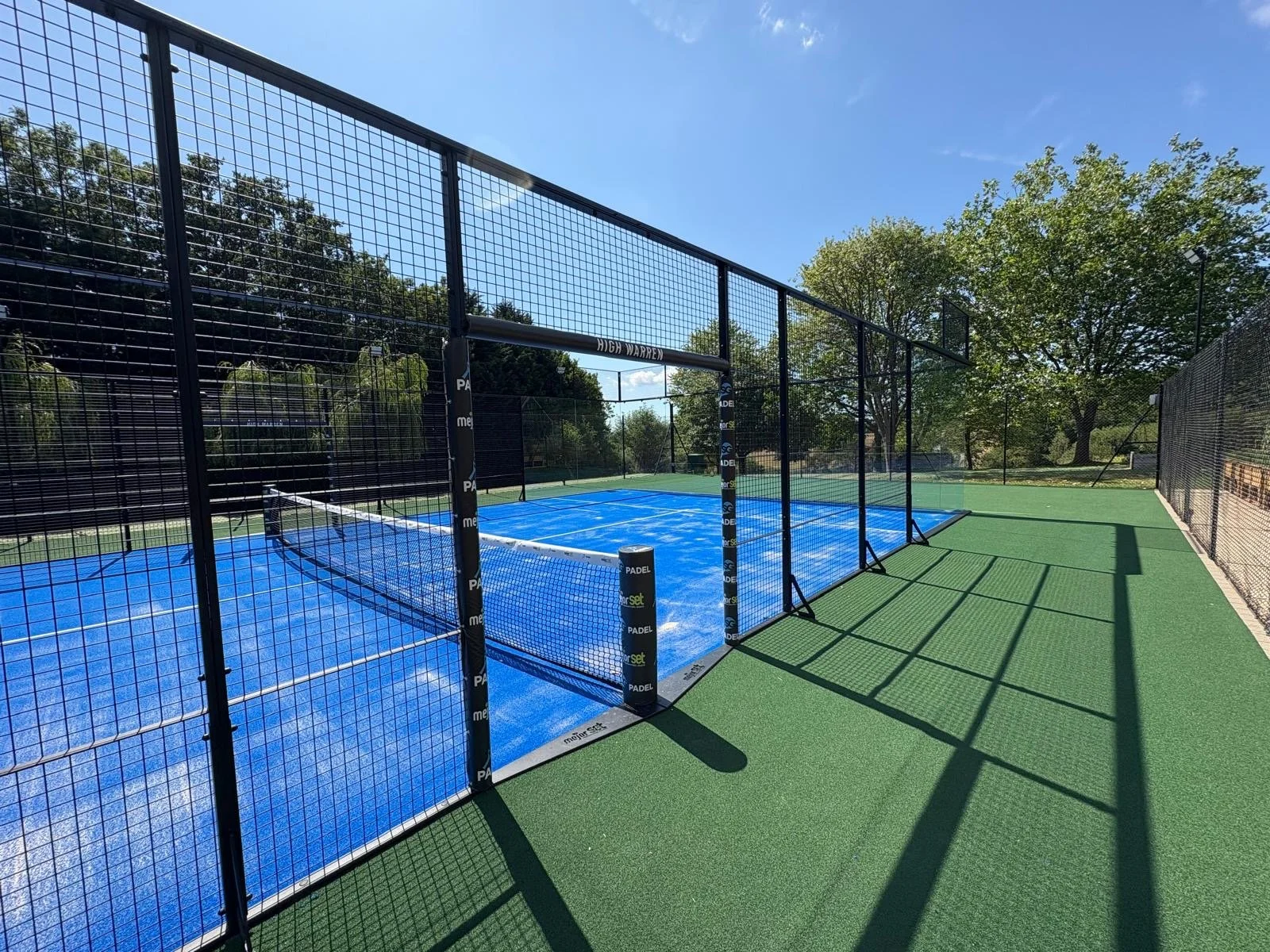 Fully Panoramic MejorSet Padel Court. UK Private residence. Private garden. Blue Turf Court,  Black Frame,  green perimeter.