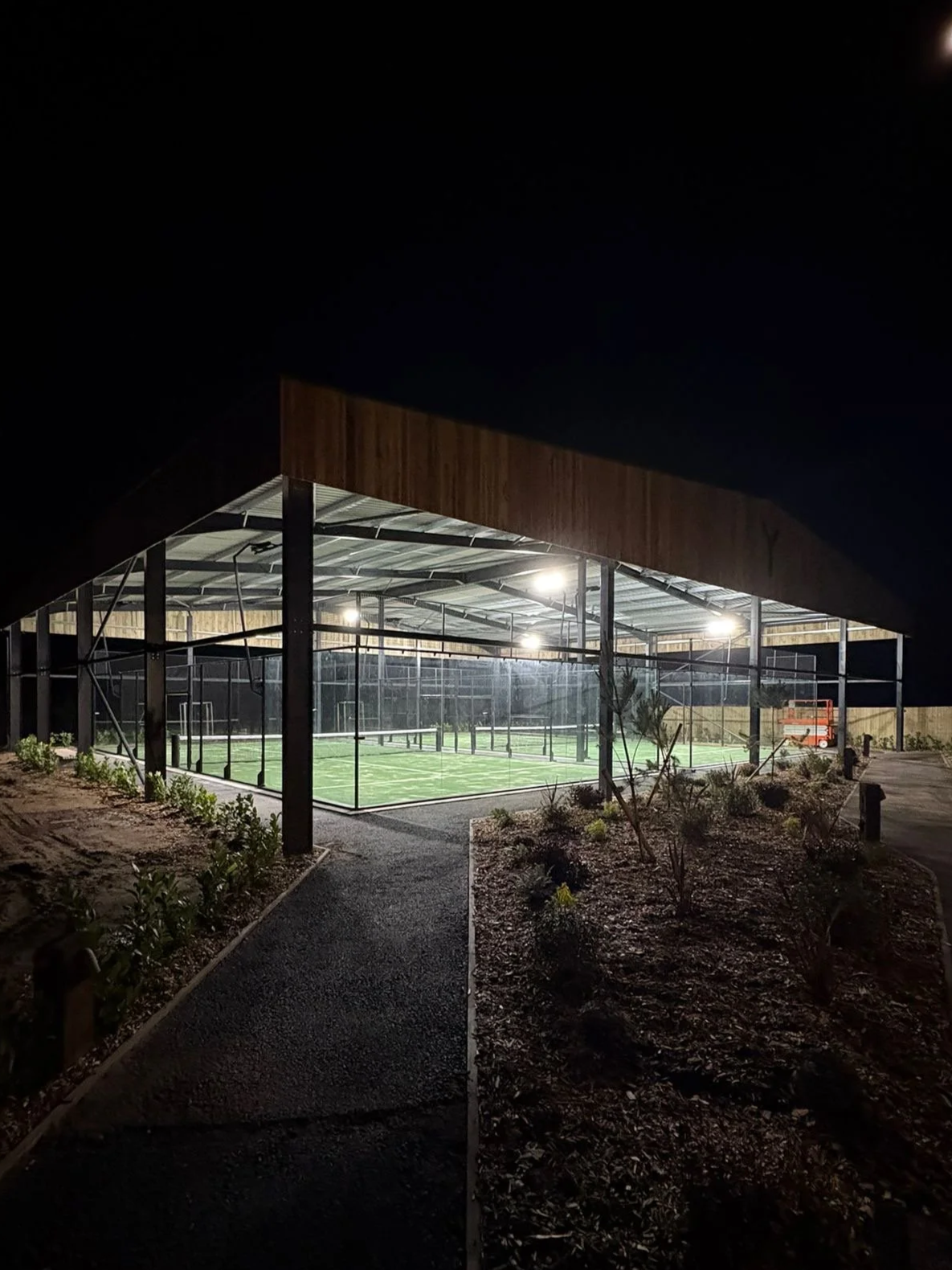 Night view of outdoor Padel facility. The Canopy is illuminating the courts.