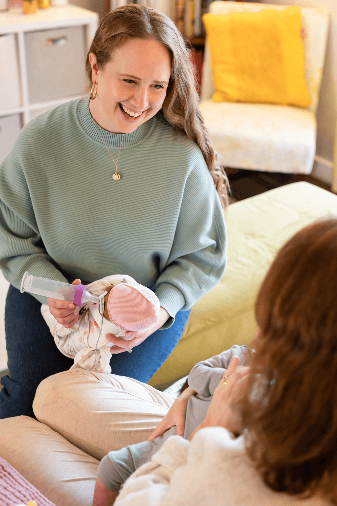 Mary Farrelly provides preemie education and NICU support for parents by demonstrating for the bottle feed a newborn.
