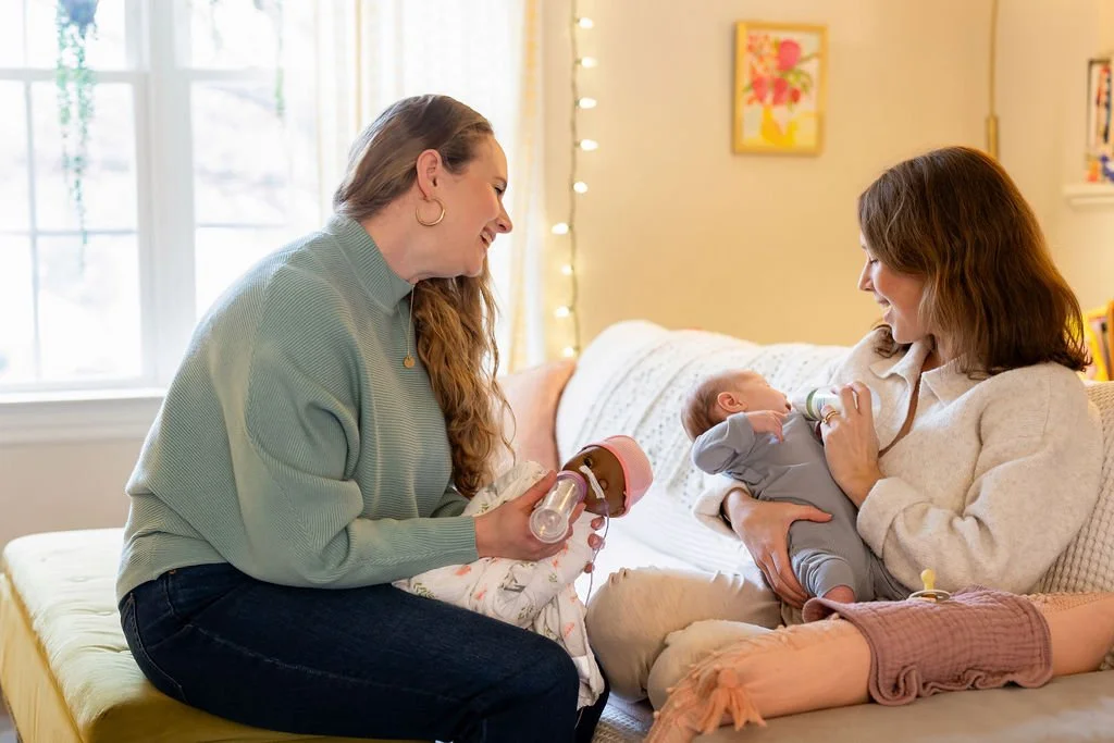 nicu doula demonstrates how to feed a baby a bottle with her client and baby
