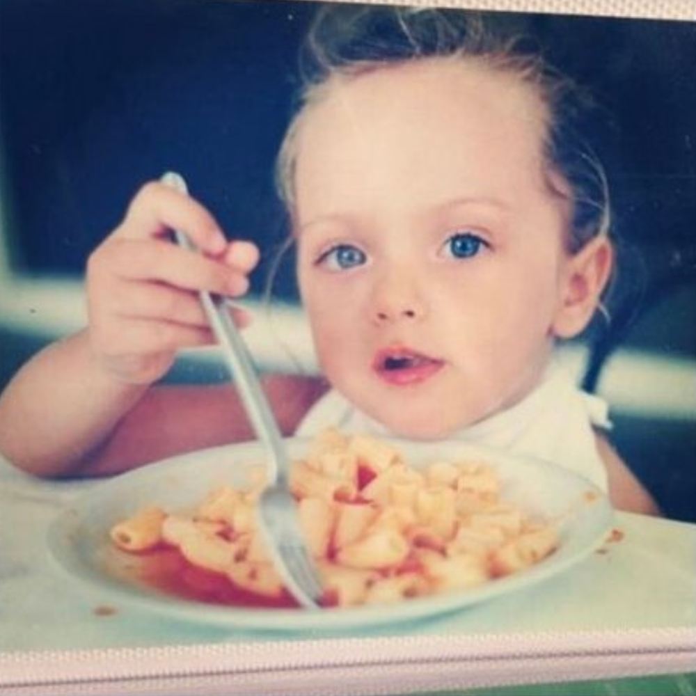 child+baby+nicole+bono+eating+pasta+.webp