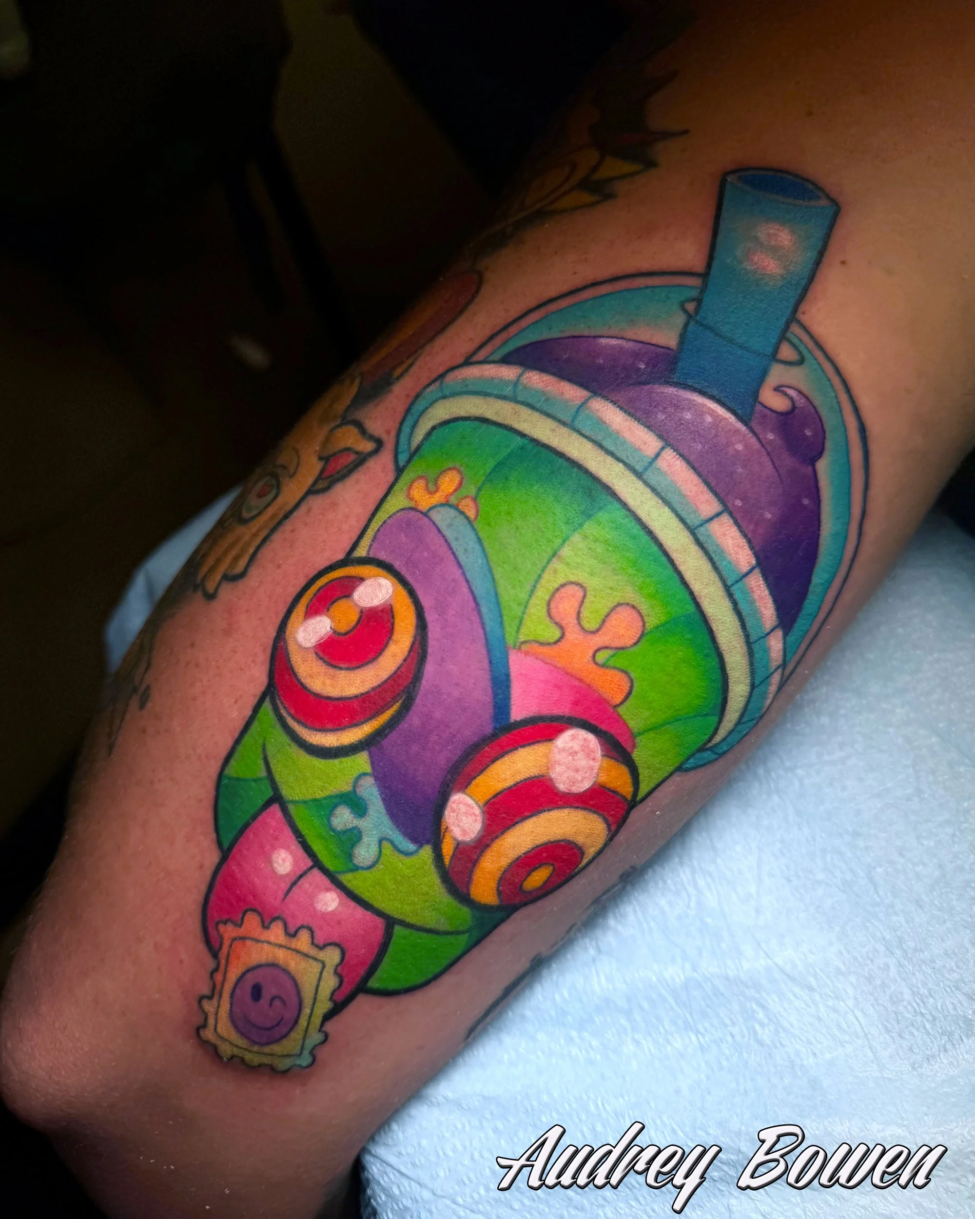 Colorful tattoo of a  rainbow slurpie, a smiling cloud, and abstract shapes. Tattoo by Audrey Bowen, Karmic Tattoo, Clearwater Florida