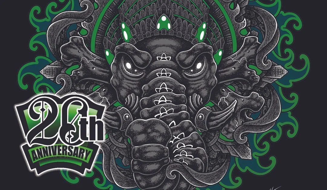 A stylized, fierce-looking black dragon with white highlights, staring forward with bright eyes, surrounded by green swirling patterns. A logo in the lower left corner reads '28th Anniversary' in black and green text.